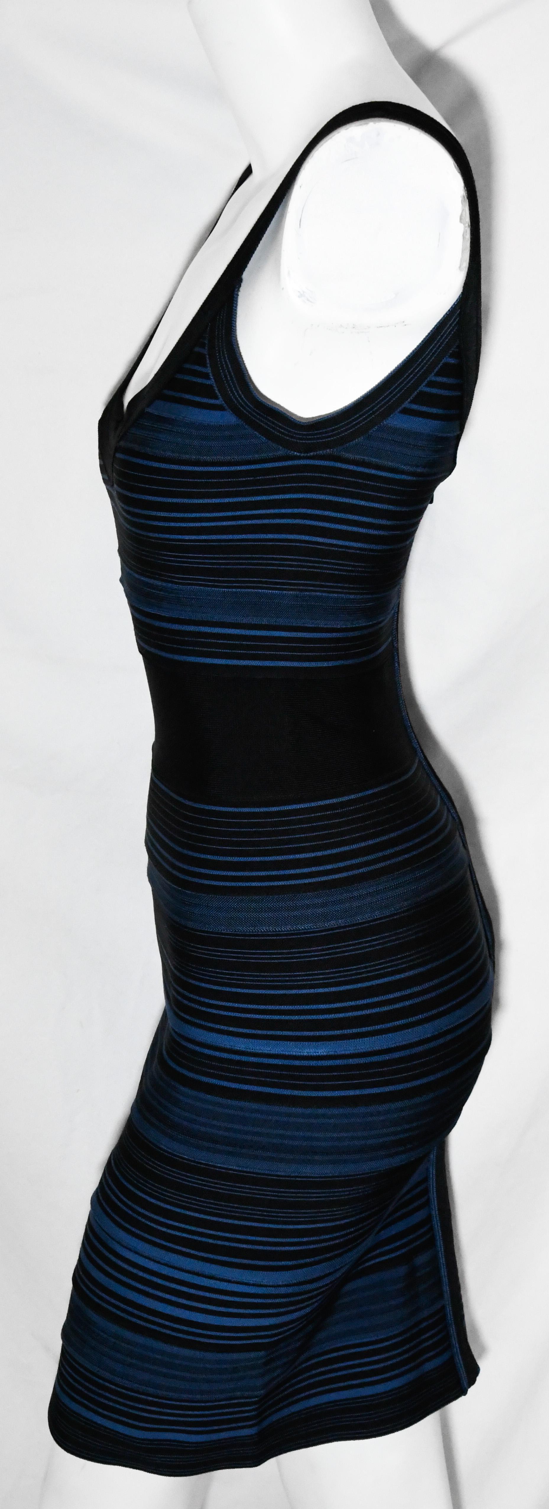 Herve Leger black and blue bandage striped dress includes low cut scoop neck and cinched band waist.  This dress has an exposed back zipper, for closure.  The dress is unlined.   Dress is in excellent condition.  