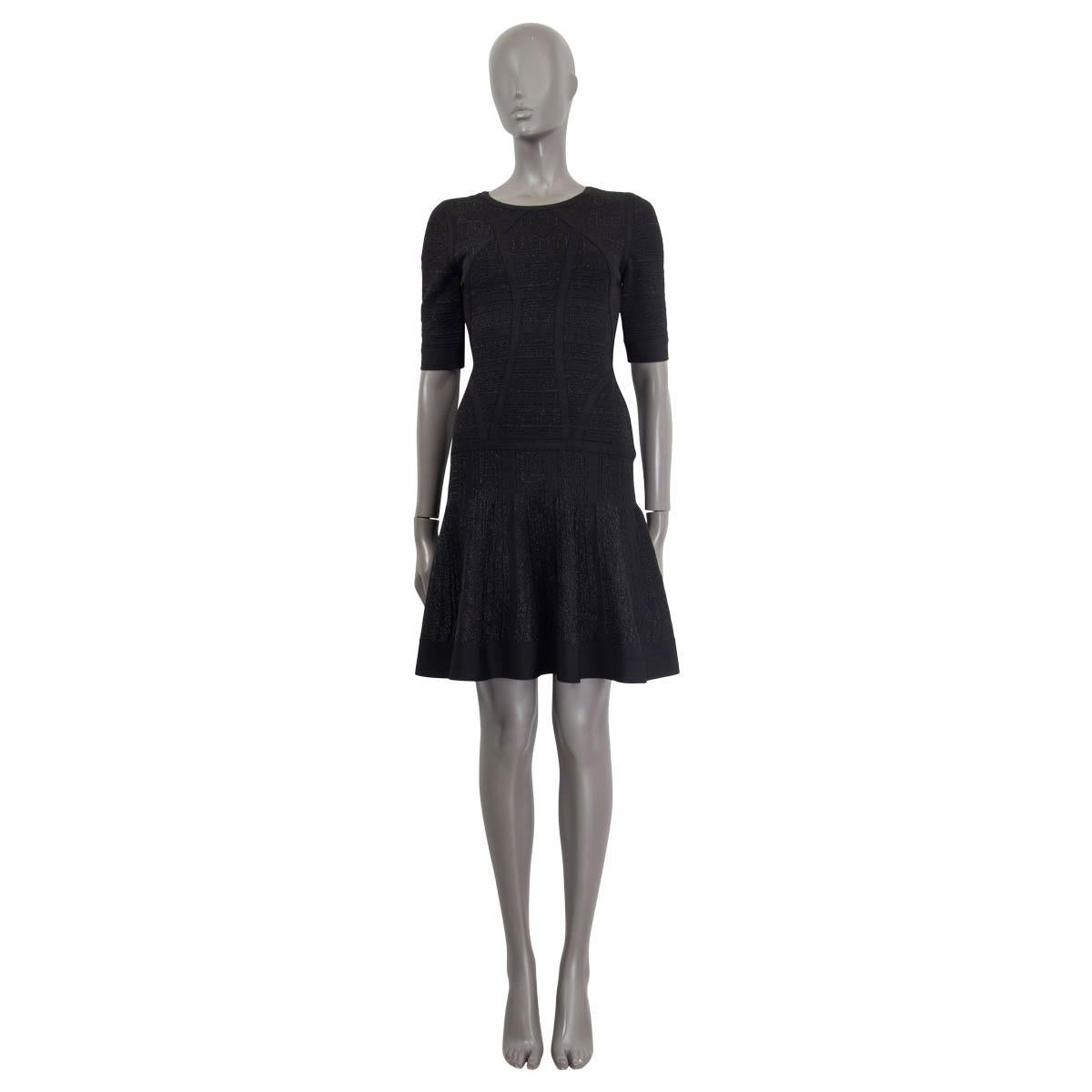 100% authentic Herve Leger Clara drop-waist dress in black rayon (75%), nylon (24%) and spandex (1%). Has a round neckline, shimmering black lurex threads and short sleeves. Opens with a concealed zipper and a hook at back. Unlined. Has been worn