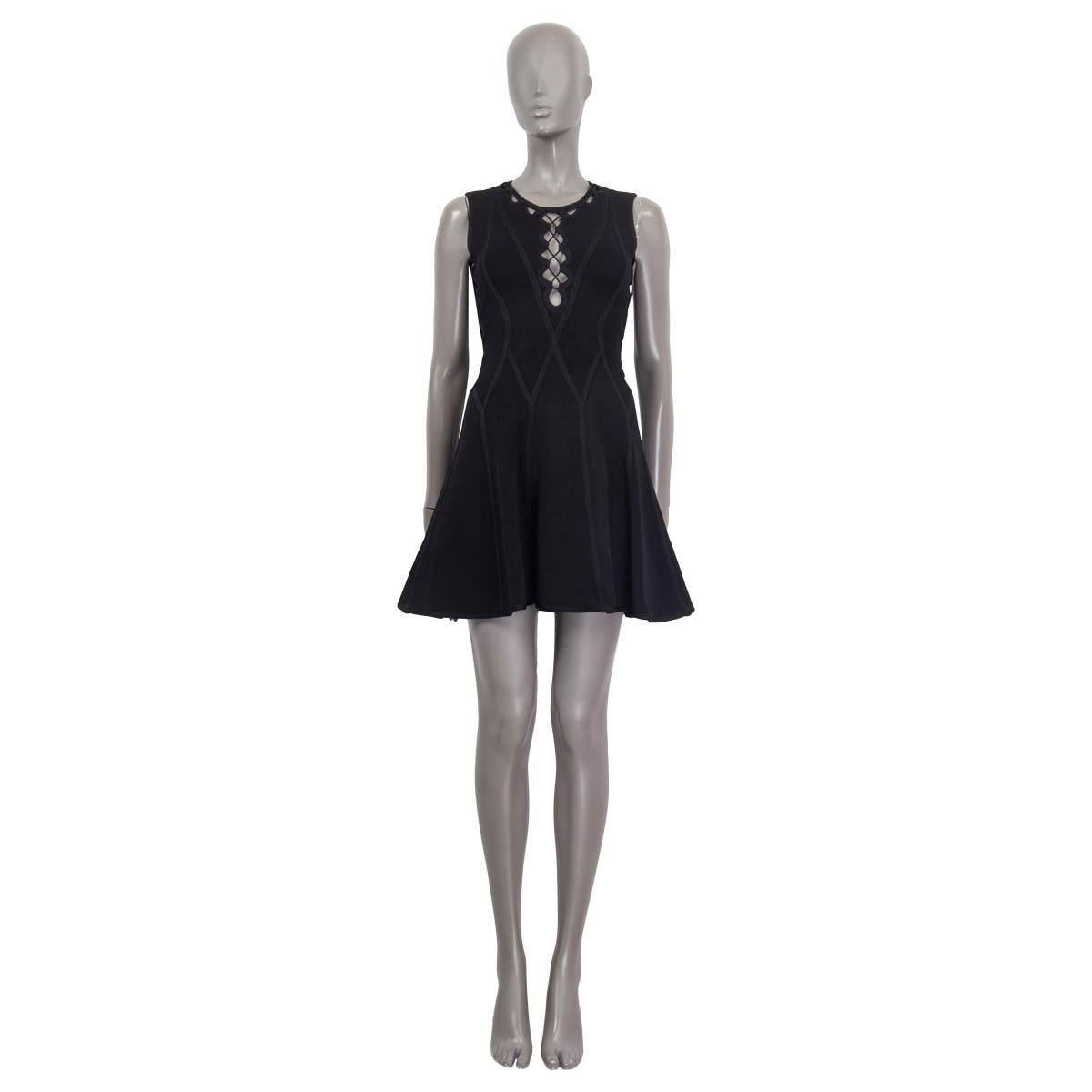 100% authentic Herve Leger flared dress in black rayon (90%), nylon (9%) and spandex (1%). Features cut out details at the sides and the neck. Opens with a zipper and a hook at the back. Unlined. Has been worn and is in excellent condition.