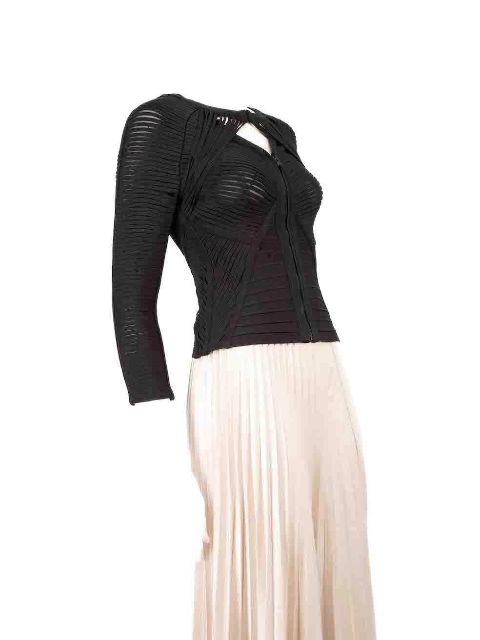 CONDITION is Very good. Minimal wear to top is evident. One seam of a strap is loosen on the rear of this used Herve Leger designer resale item.
 
 
 
 Details
 
 
 Black
 
 Rayon
 
 Top
 
 Long sleeves
 
 Strappy detail
 
 Round neck
 
 Front hook