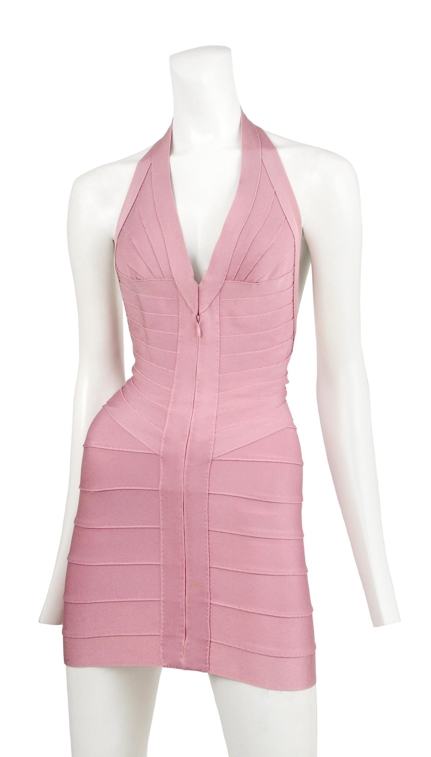 Herve Leger classic rose pink bandage halter mini dress in rose pink. Features deep V neckline, hook and eye closure at neckline, full zipper at center front, and open back. Hand stitched and made in France.

Excellent Vintage Condition.