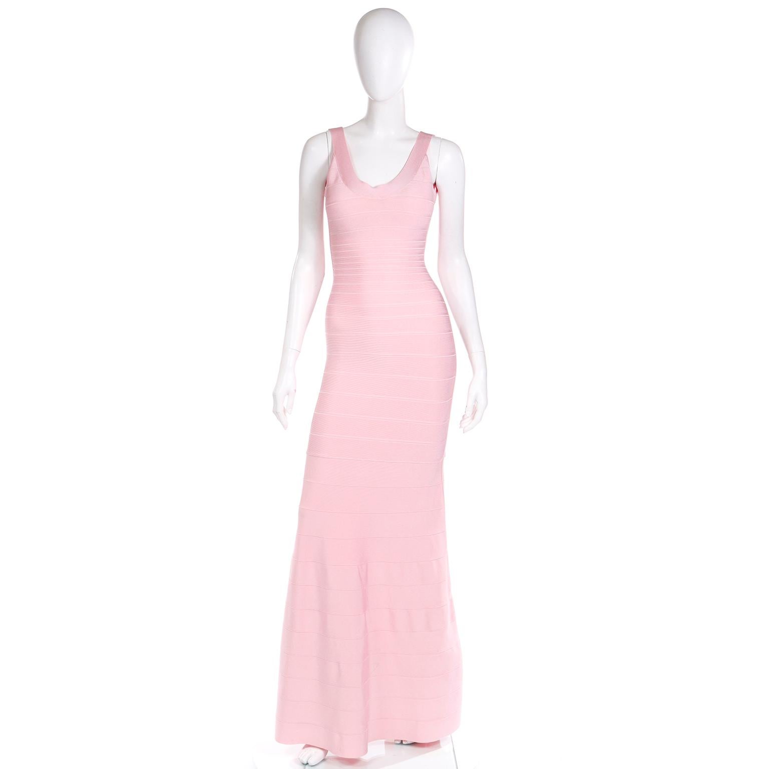 This pretty Herve Leger full length bandage dress is in a pretty pale cotton candy pink.  The dress has sewn in bra cups and a concealed 13