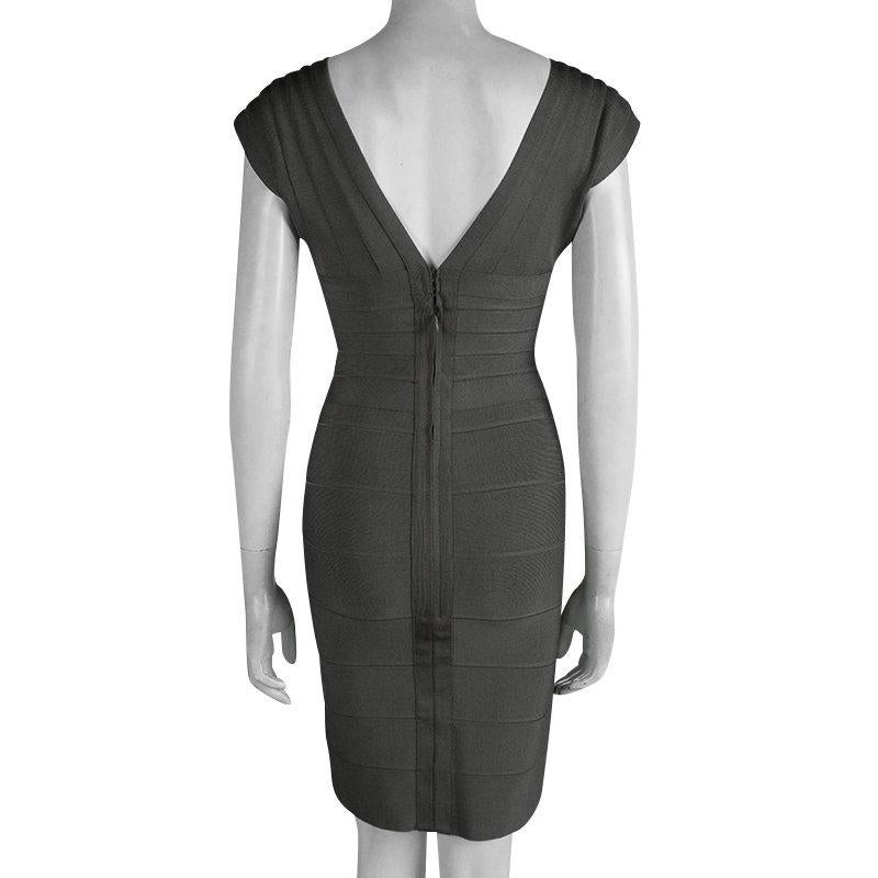 This stunning dress from the house of Herve Leger is designed in the signature body-sculpting bandage style of the house. This grey shadow dress comes with a deep V-neckline, short cap sleeves and a rear zip closure. Wear with metallic sandals and