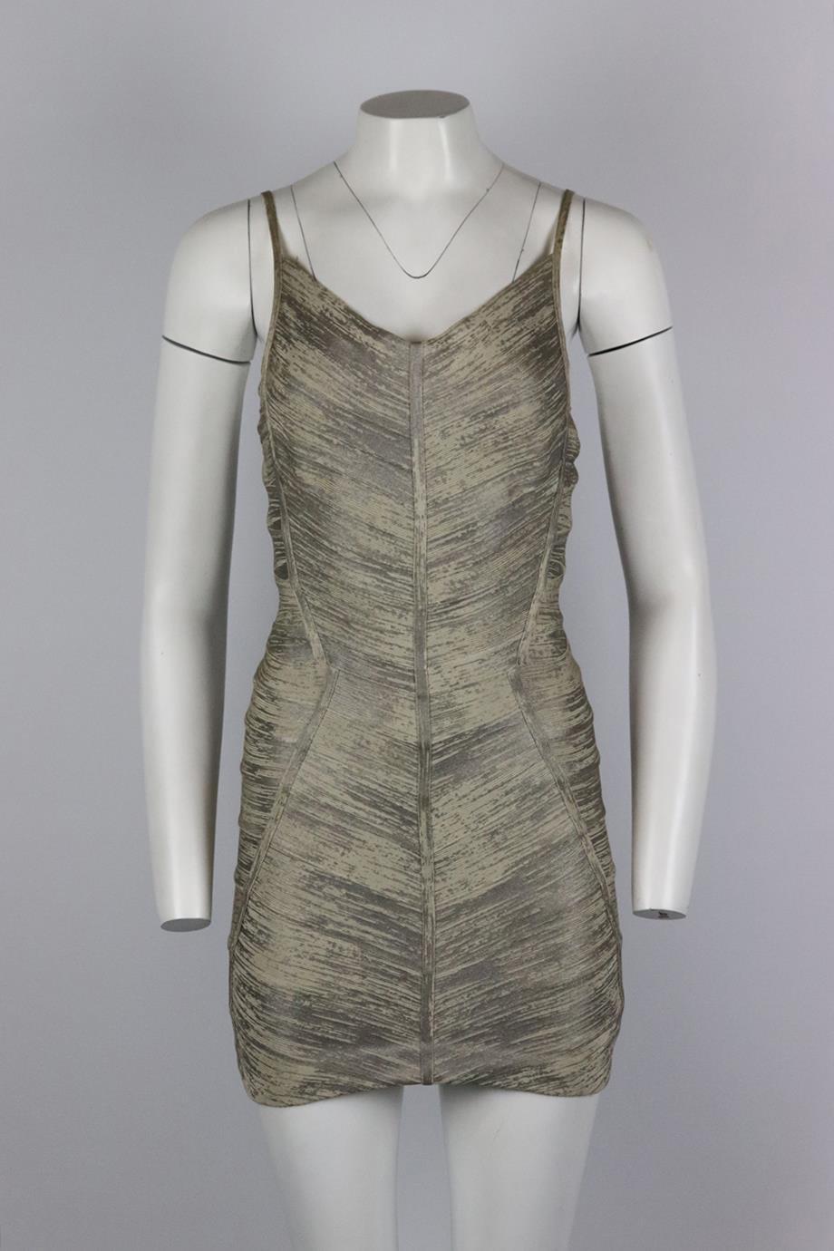 Herve Leger metallic coated bandage mini dress. Silver and beige. Sleeveless, v-neck. Zip fastening at back. 90% Rayon, 9% nylon, 1% spandex. Size: Small (UK 8, US 4, FR 36, IT 40). Bust: 32 in. Waist: 28 in. Hips: 36 in. Length: 32 in. Fair