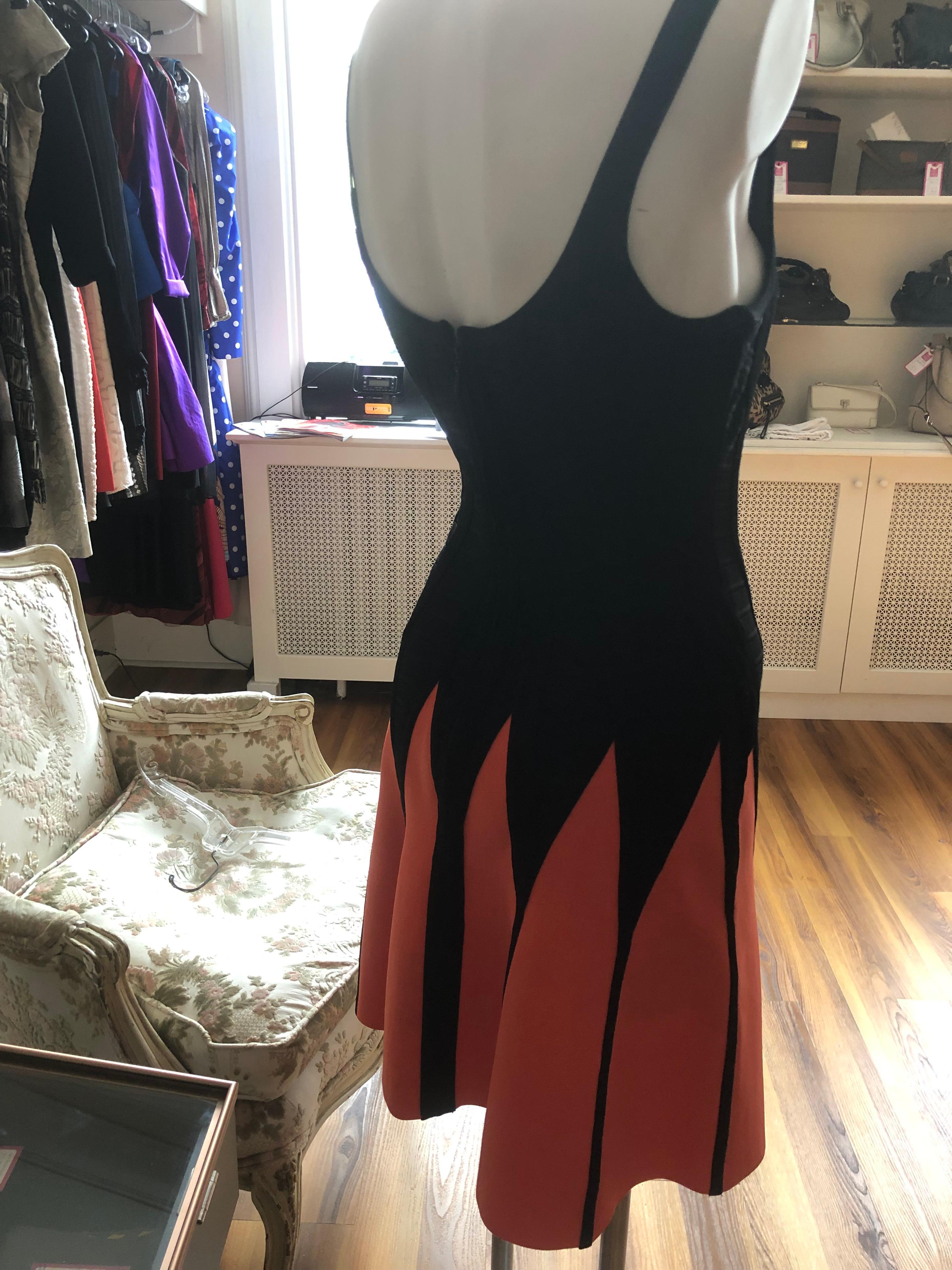 Iconic black and orange jagged design bandeau dress, with an A-line fit and flare skirt. There is a hidden back zipper, and look at the details on the bodice. 