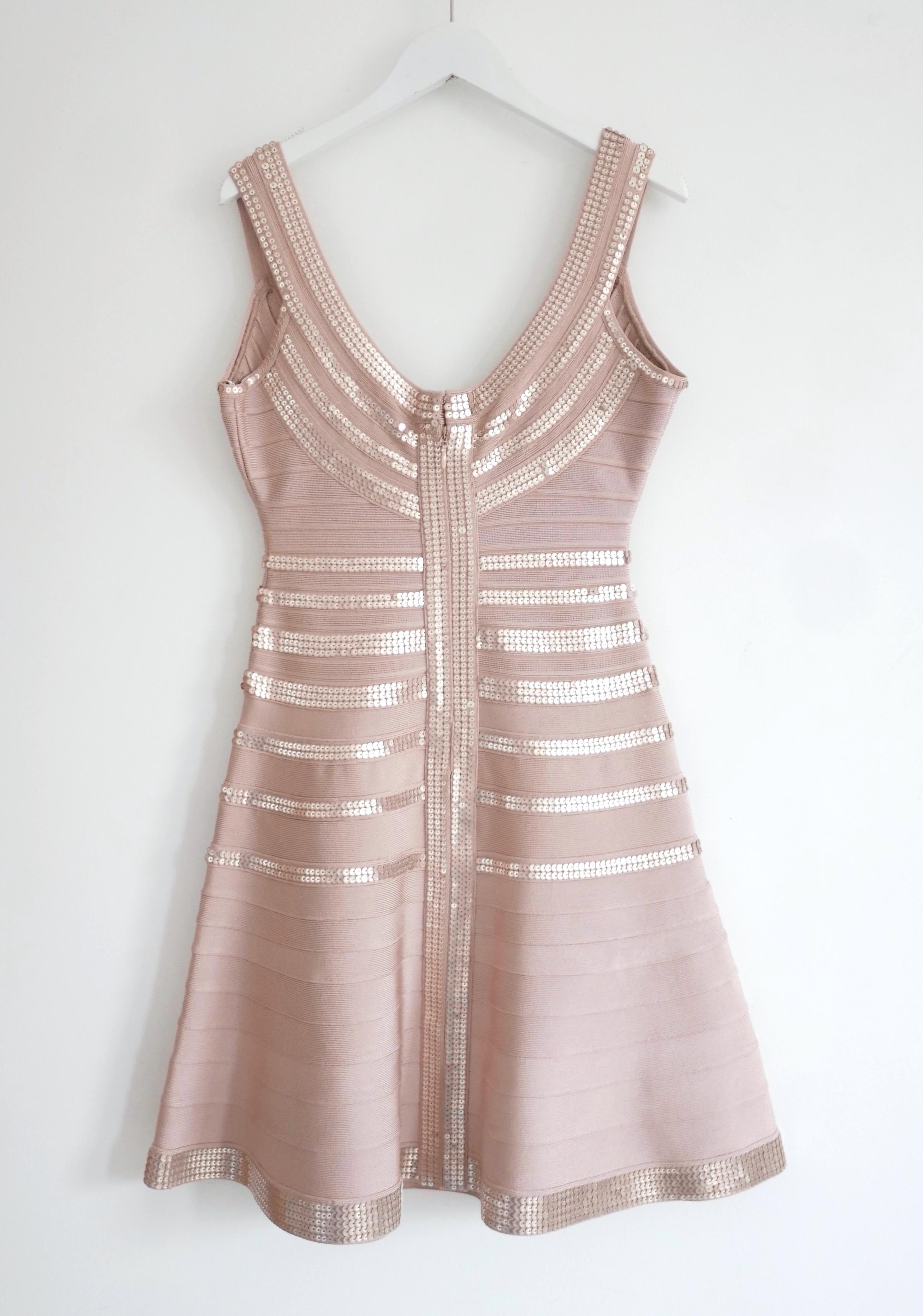 
Stunning Herve Leger Sachie sequin bandage dress - bought for £1125 and unworn. Made from Leger's signature super stretchy, thick 'cinch you in' rayon mix in a classic nude pink shade and has bands of sparkling sequins through the bodice and at the