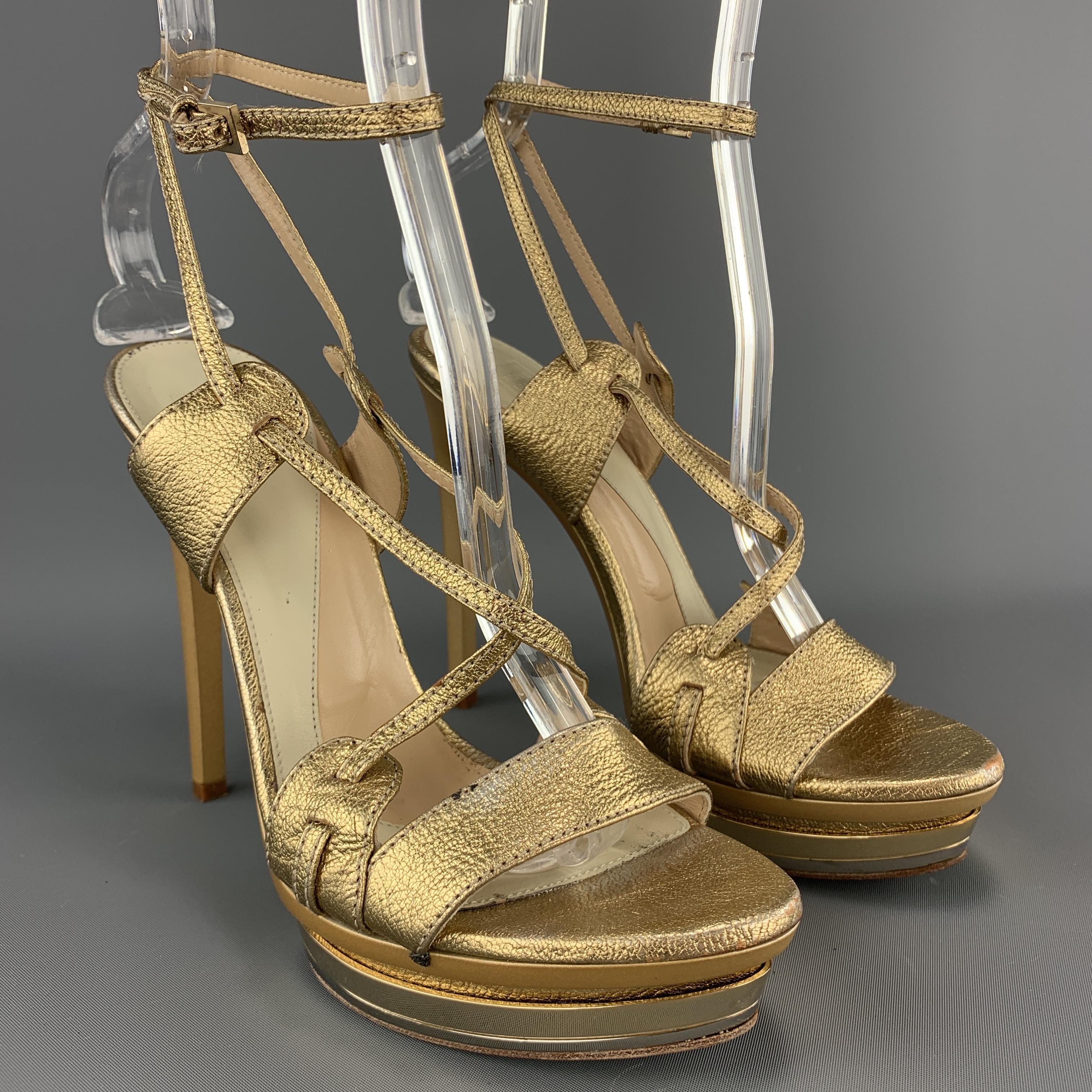 HERVE LEGER sandals come in metallic gold leather with a strappy front and mirrored platform. Wear throughout. 

Fair Pre-Owned Condition.
Marked: (no size)

Heel: 5.25 in.
Platform: 1.25 in.