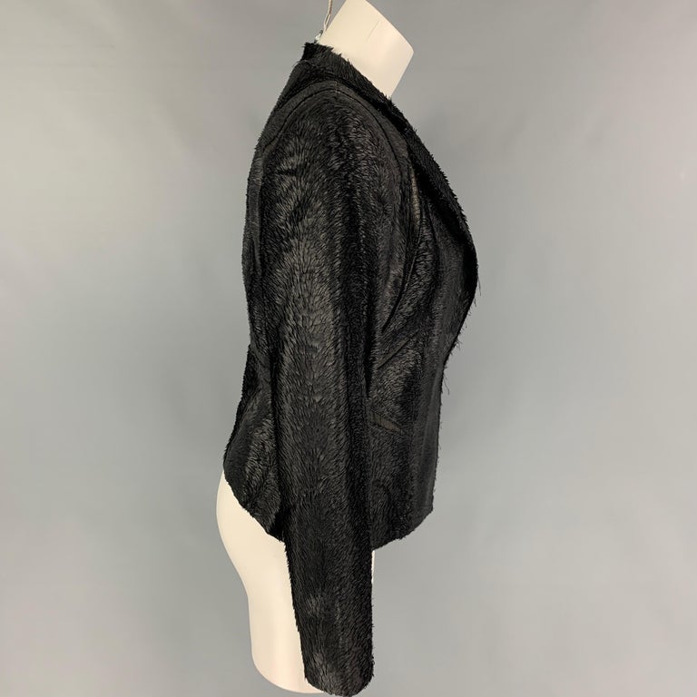 HERVE LEGER blazer comes in a black textured material featuring a leather trim, notch lapel, and a hook & loop closure.

Very Good Pre-Owned Condition.
Marked: S

Measurements:

Shoulder: 16 in.
Bust: 34 in.
Sleeve: 25 in.
Length: 20 in. 