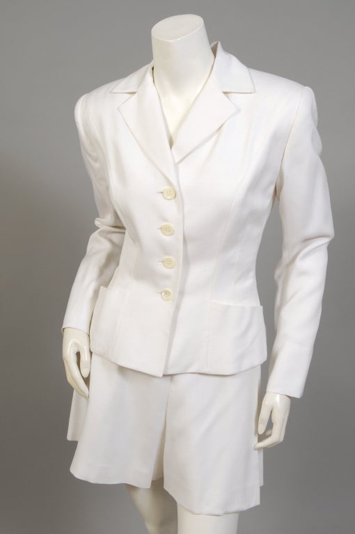 What a great summer suit this is, a trim white blazer and city shorts from Herve Leger, Paris. The jacket is cut like a traditional blazer, with an added bit of French flair. The shorts have a button front like vintage sailor pants. Both pieces are