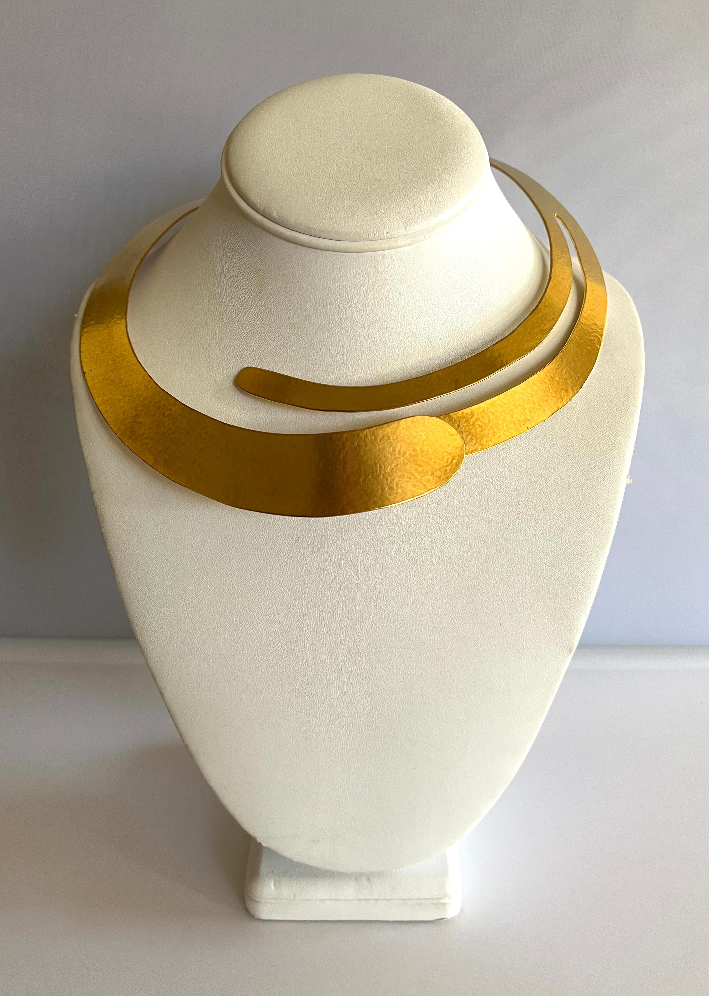 Hand-crafted contemporary hammered gilt metal asymmetrical statement necklace by Herve Van Der Straeten - made in Paris circa 2000s. Singed HVD.
The necklace opens up to accommodate any size neck and has an extender chain.