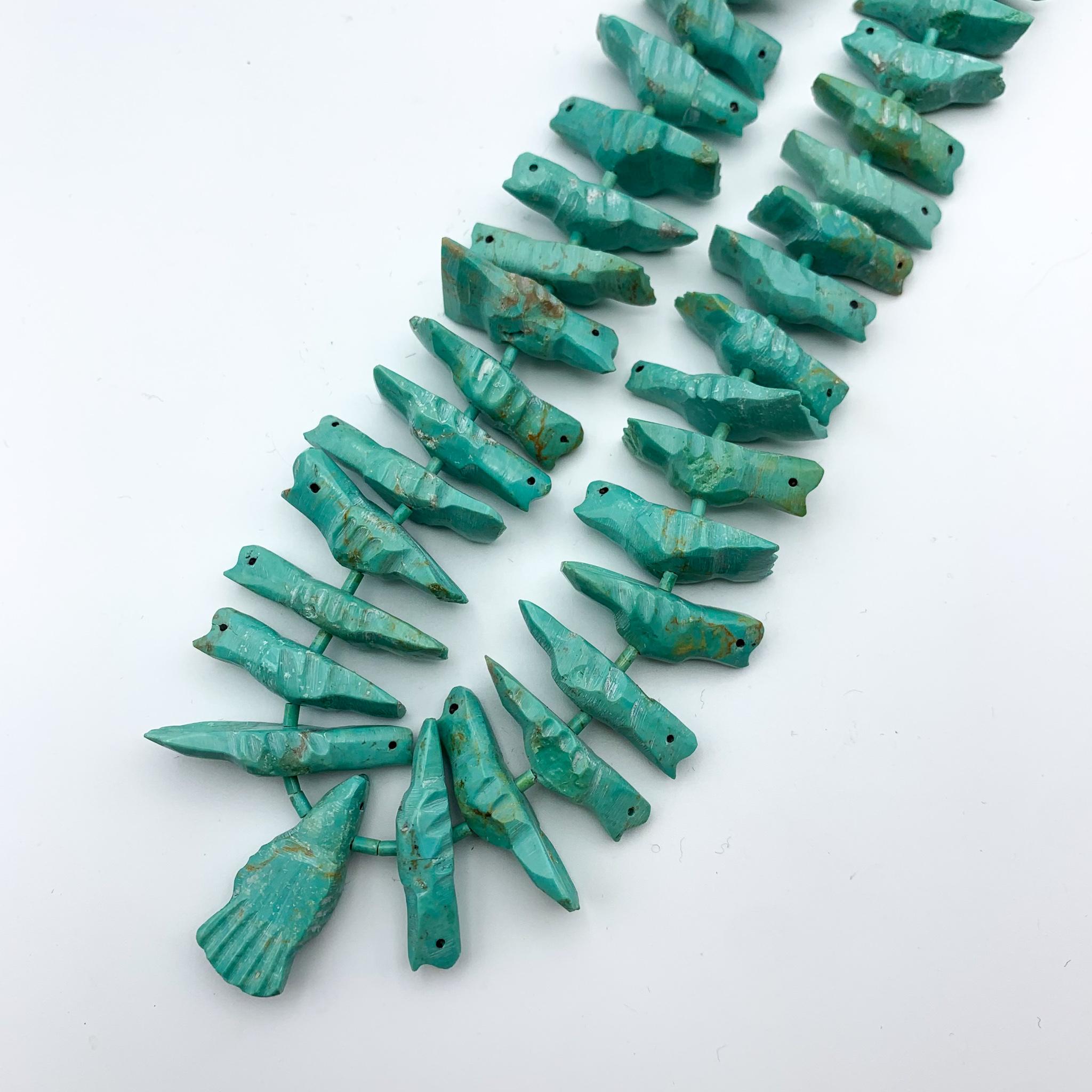 Heshi turquoise fish necklace strung with a silver clasp.