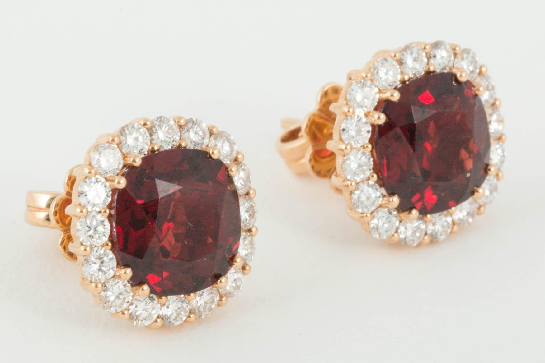 Cushion shaped Hessanite Garnets surrounded by Diamonds set in 18ct Gold. Th eHessanites are natural untreated stones