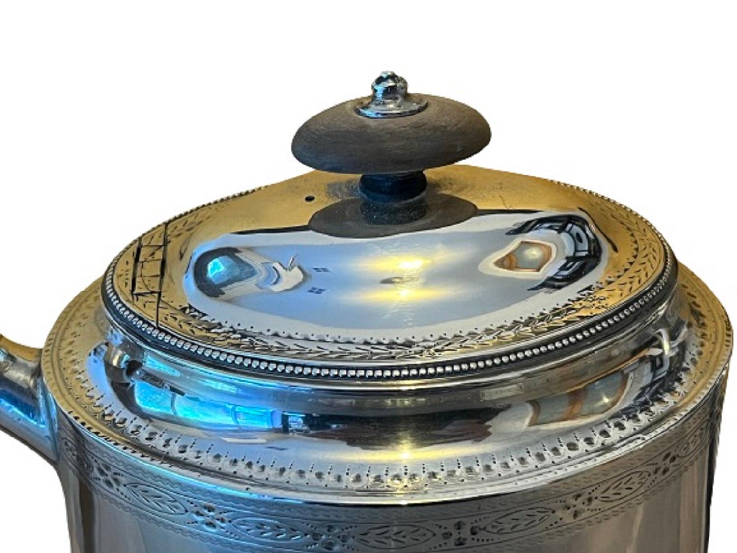 HESTER BATEMAN
A very attractive George III silver neoclassical teapot, oval straight-sided body with straight spout and bright-cut engraving, the domed lid with flush hinge and applied bead mount detail. The body with two blank escutcheon shaped