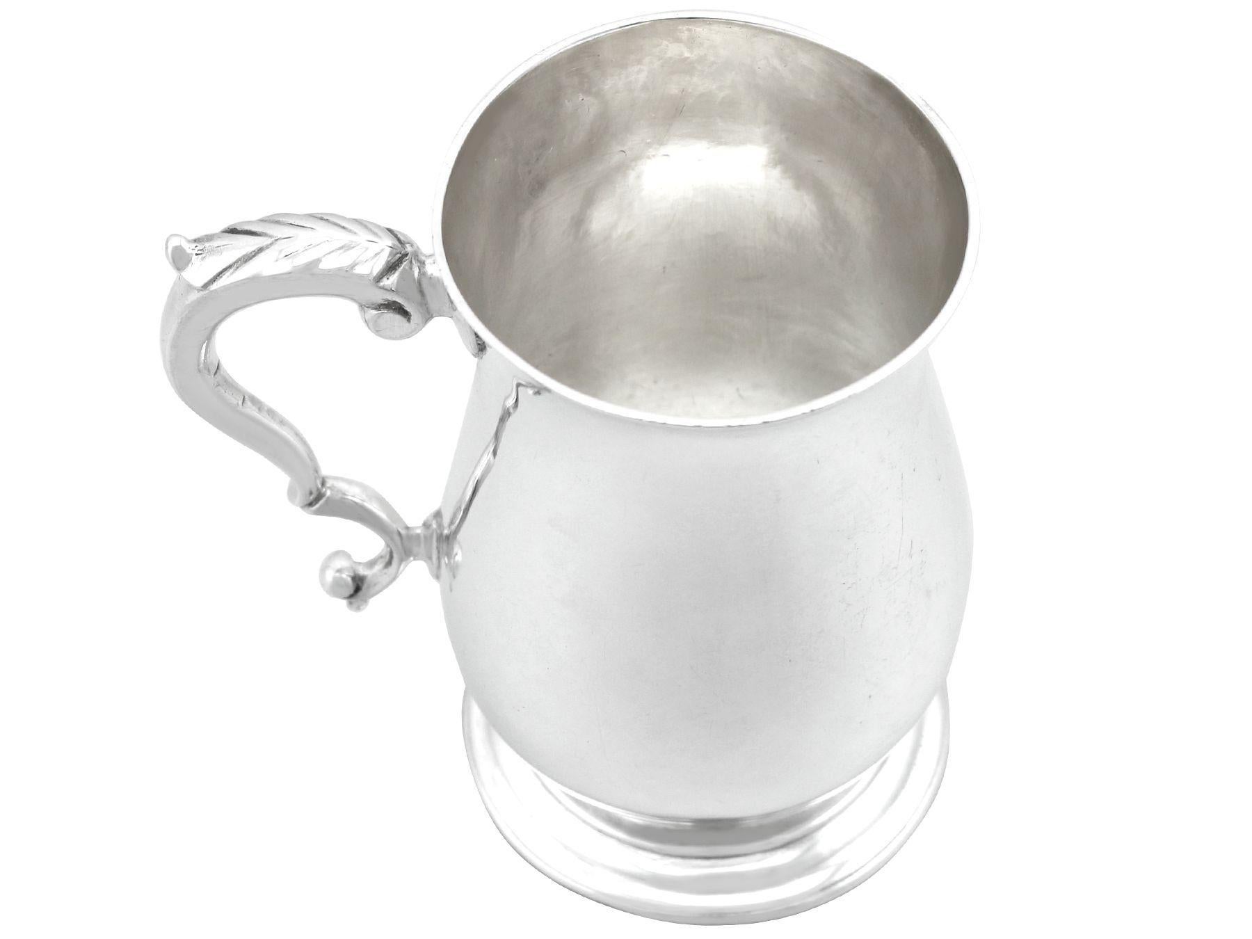 An exceptional, fine and impressive antique George III English sterling silver lady's mug; an addition to our Georgian silverware collection.

This exceptional antique George III sterling silver mug has a plain baluster form onto a circular domed