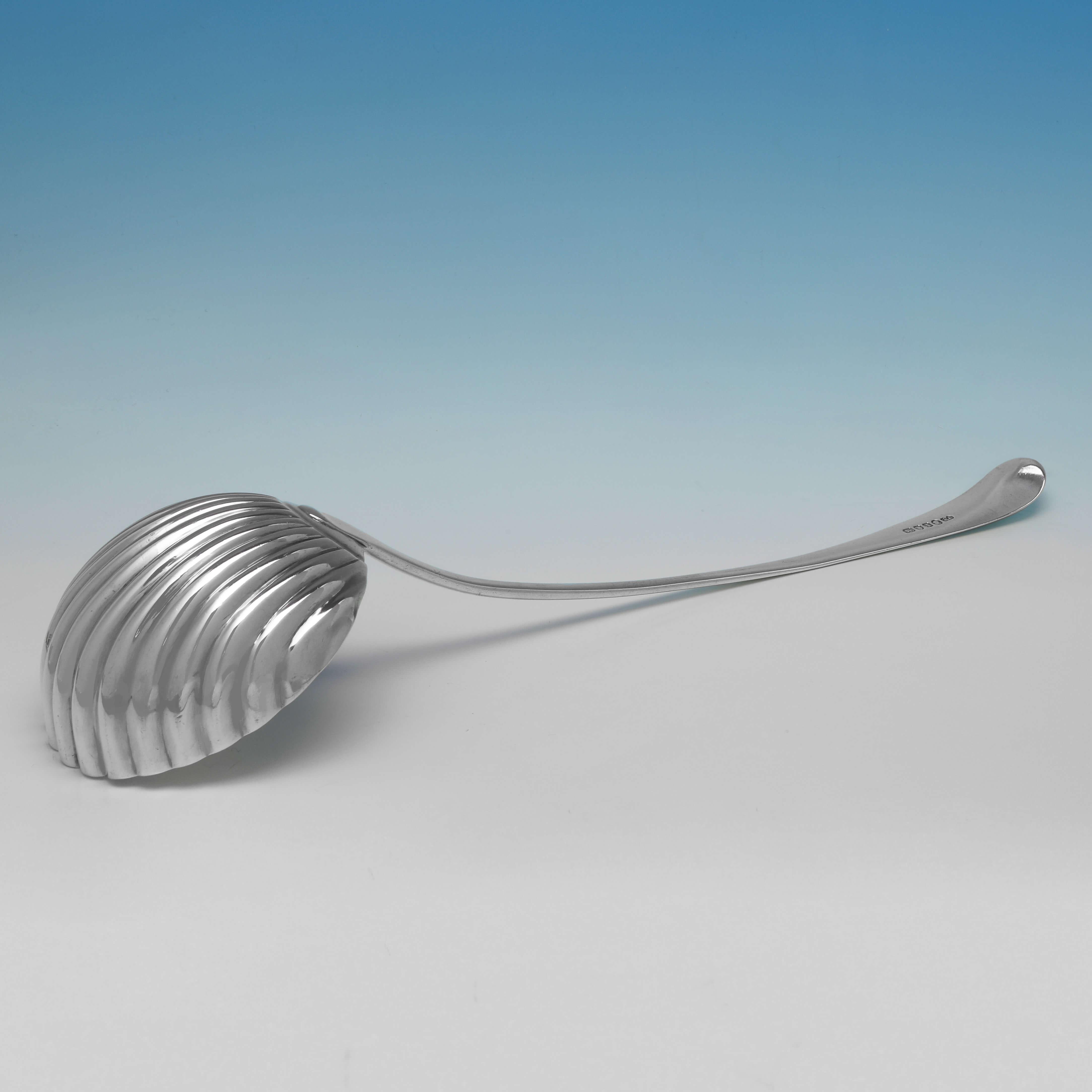 Hallmarked in London in 1786 by Hester Bateman, this attractive, neoclassical, antique sterling silver soup ladle, or punch ladle, features a shell bowl, and an engraved crest to the handle. The soup ladle measures 14.25