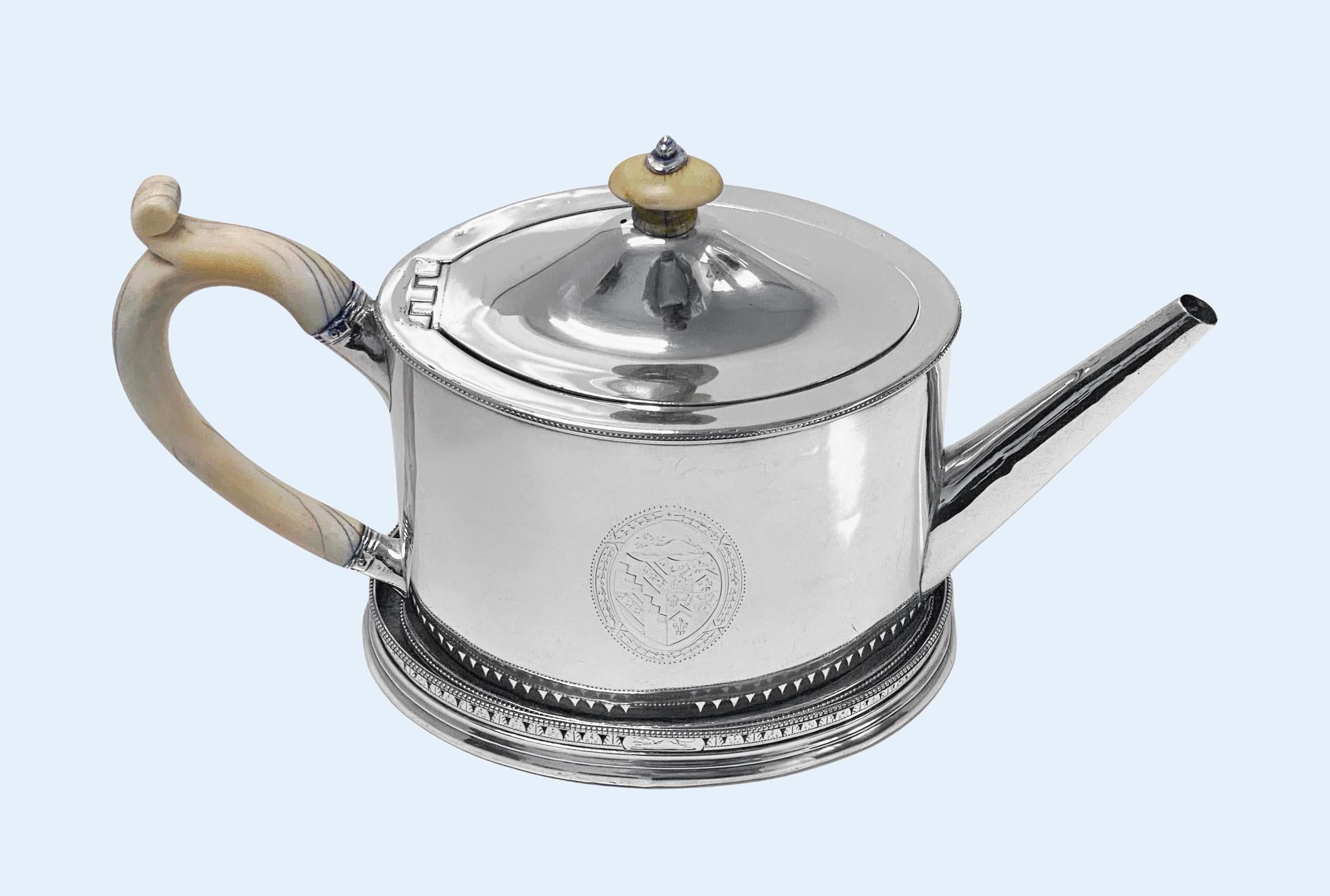Hester Bateman Georgian Silver Teapot and stand London 1788. Accompanied by a rare silver stand, elegant plain teapot, with its oval, straight-bodied shape and composite handle and finial, with upper and lower bead border. Oval stand hand engraved