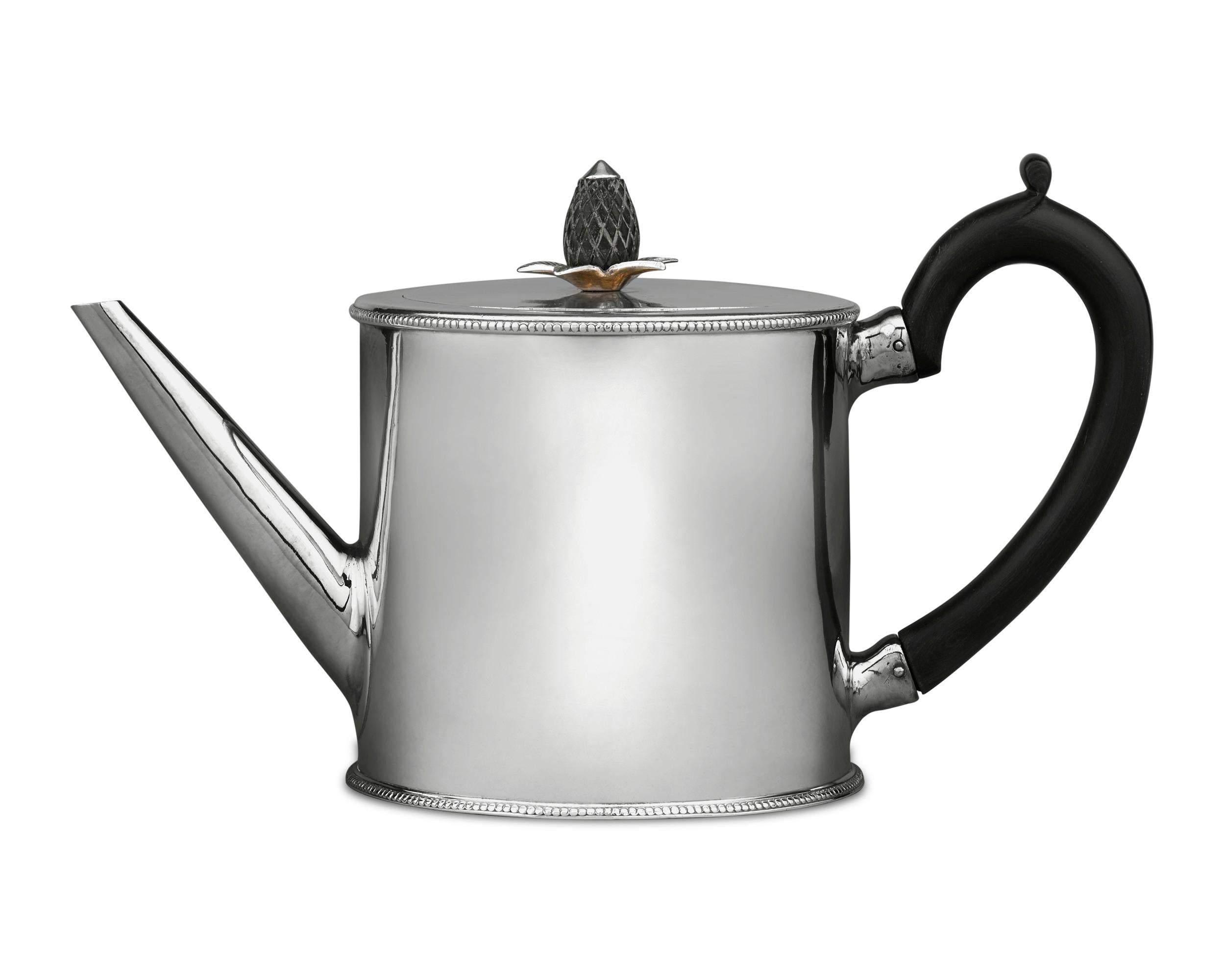 A work of refinement, this George III silver teapot was crafted by the legendary female silversmith Hester Bateman. Its round form is accentuated by Bateman's signature beaded trim, while a pineapple finial and handle, both carved from ebony, add