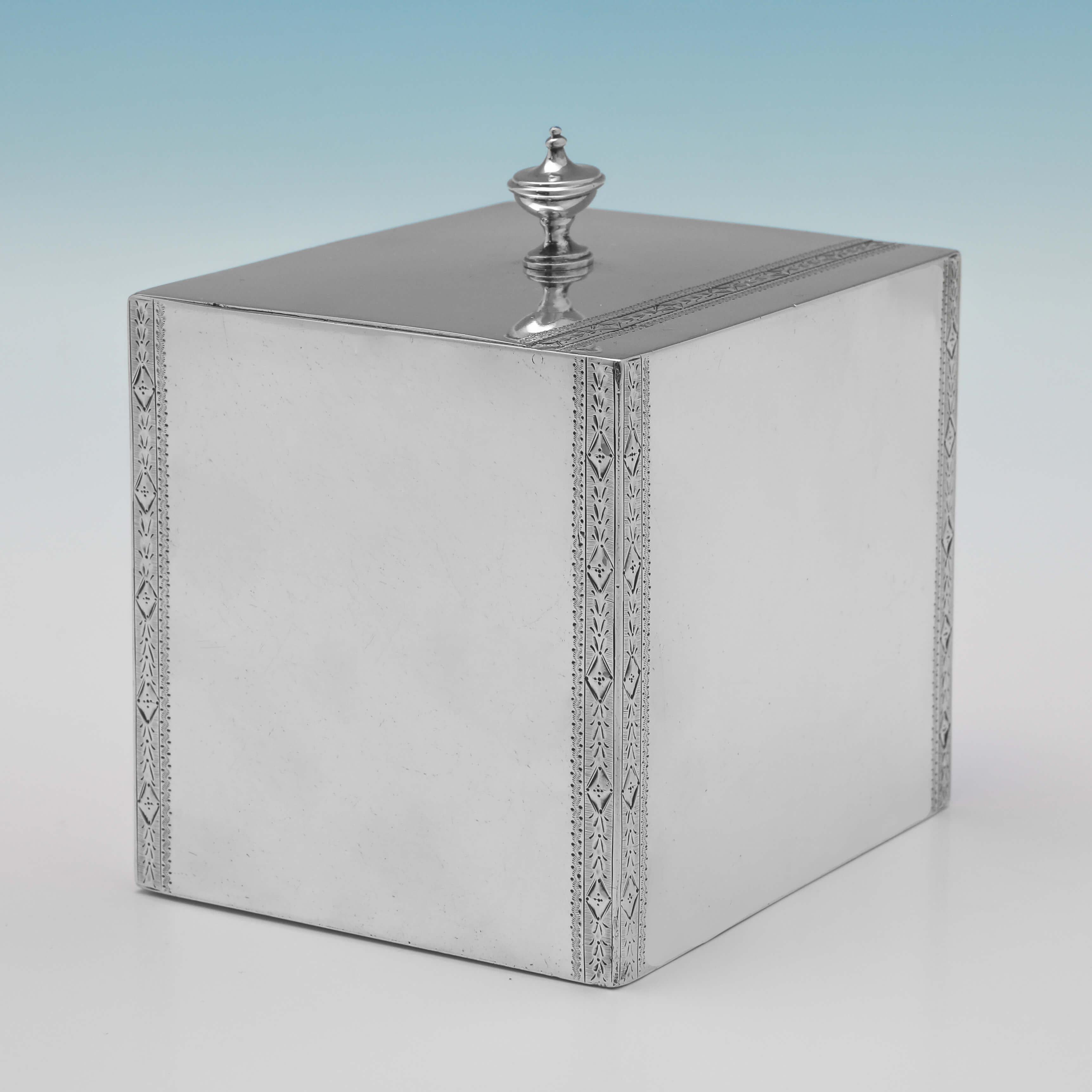 Hallmarked in London in 1784 by Hester Bateman, this very attractive, George III period, Antique Sterling Silver Tea Caddy, is of Neoclassical design, cuboid in shape, and featuring bands of bright cut engraved decoration to each edge, and over the