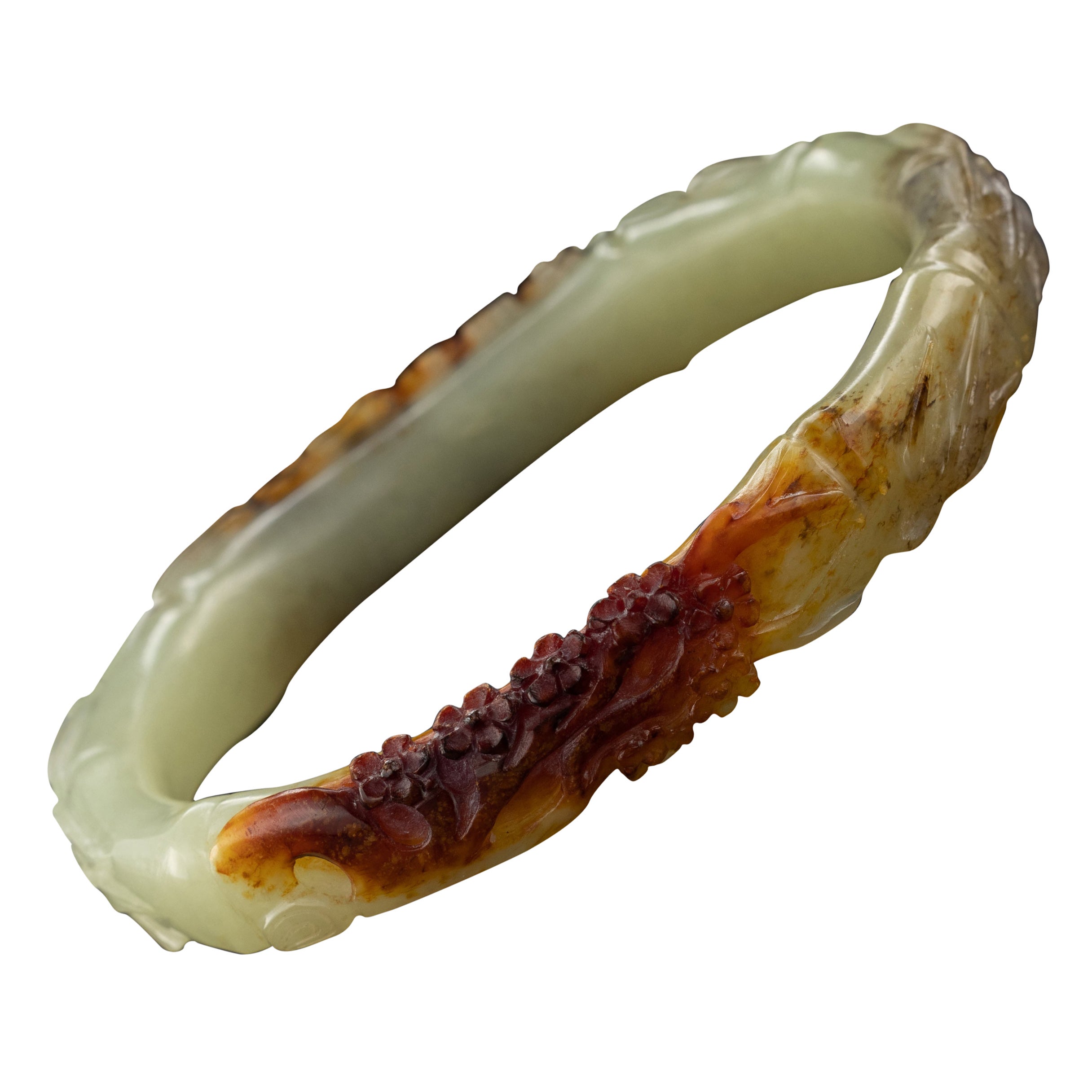A brilliant departure from the usual: this nephrite jade bangle has been hand-carved into an opal shape while retaining the nephrite jade's original reddish-orange 