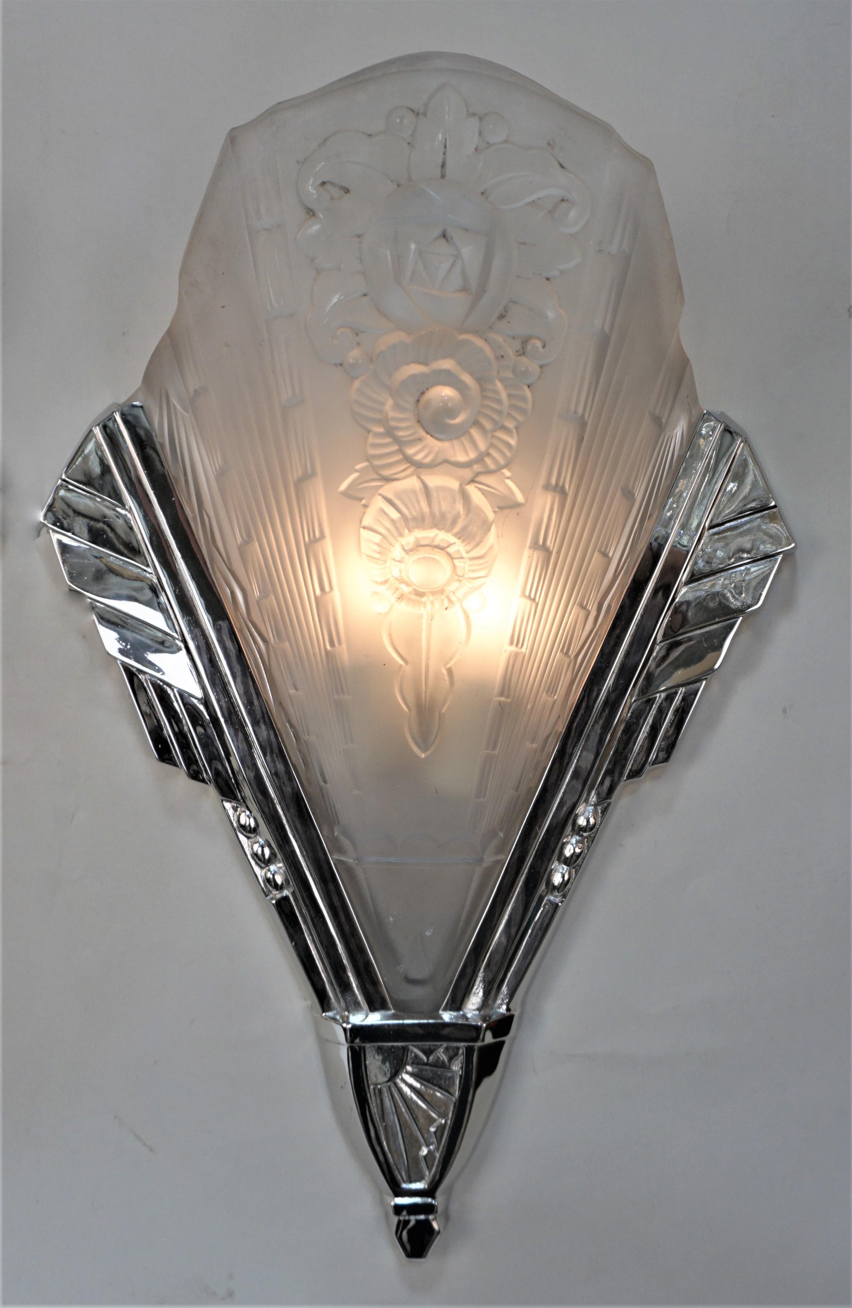 Two large pair of 1920's French art deco wall sconces in polished nickel plated on bronze and clear frosted crystal. The shades were exclusively produced for Hettier & Vincent by Baccarat. 
Sold and priced by the pair. 2 pairs.
2 lights each 75