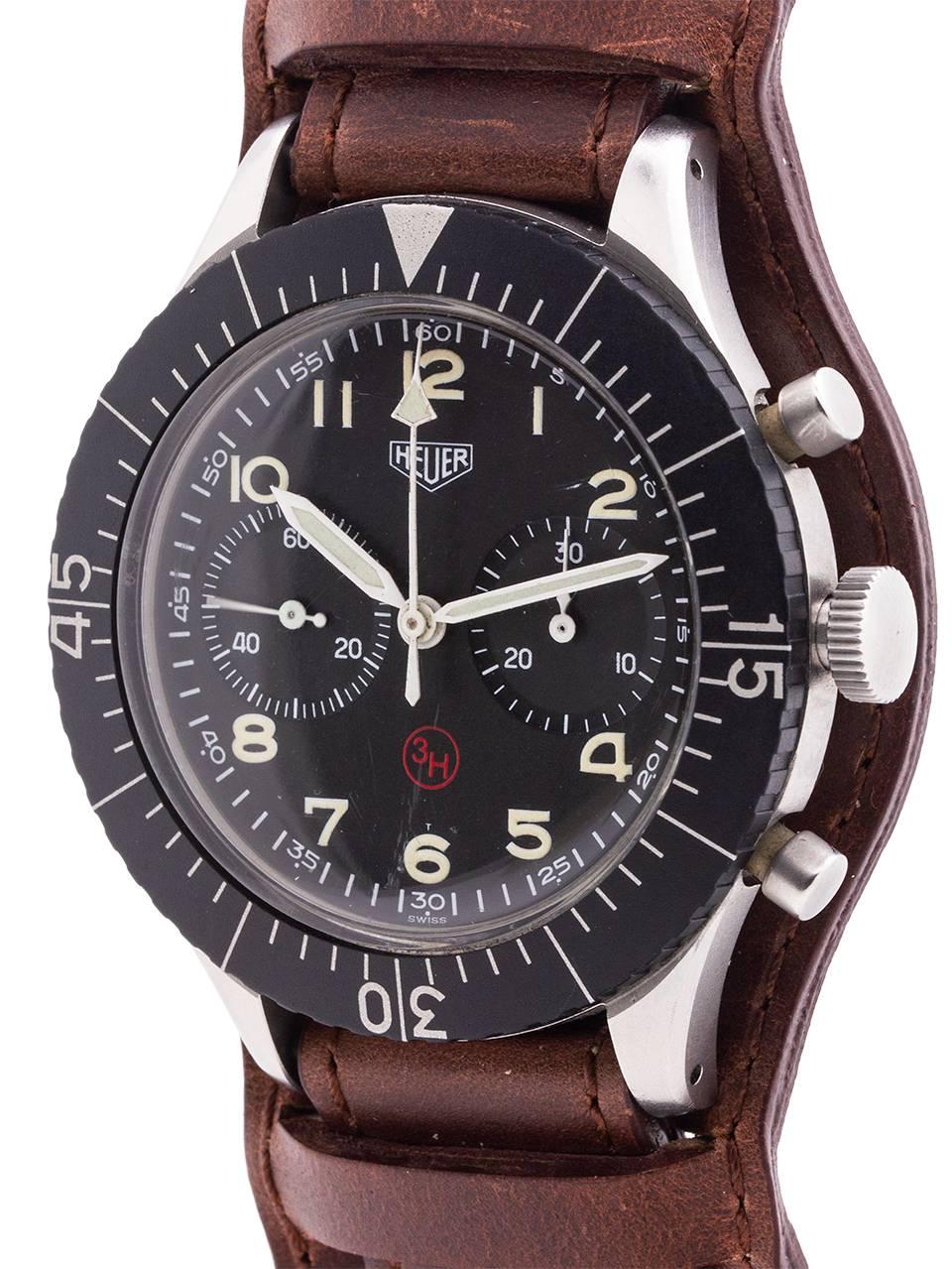Exceptional condition example Heuer German pilot’s 2 registers manual wind chronograph with flyback function circa 1960. Large 43 X 50mm brushed finish stainless steel case with wide matte black rotating elapsed time bezel, acrylic crystal, and
