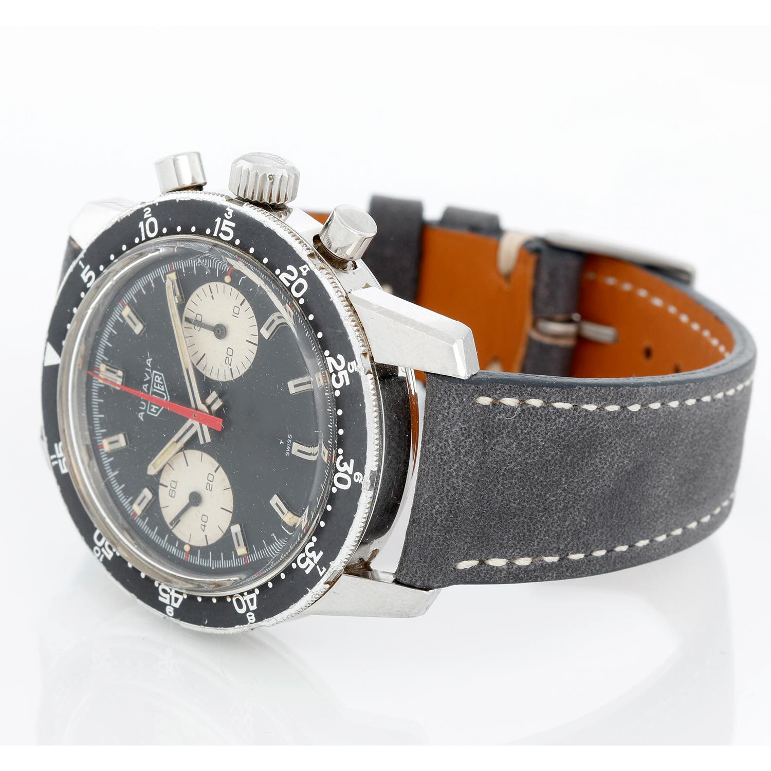 Vintage Heuer Autavia Chronograph - Manual winding. Stainless steel ( 40mm ). Black dial with silver markers and white registers with 7733 caliber movement. Strap band with buckle.  Very collectible vintage Heuer chronograph.  Pre-owned with custom