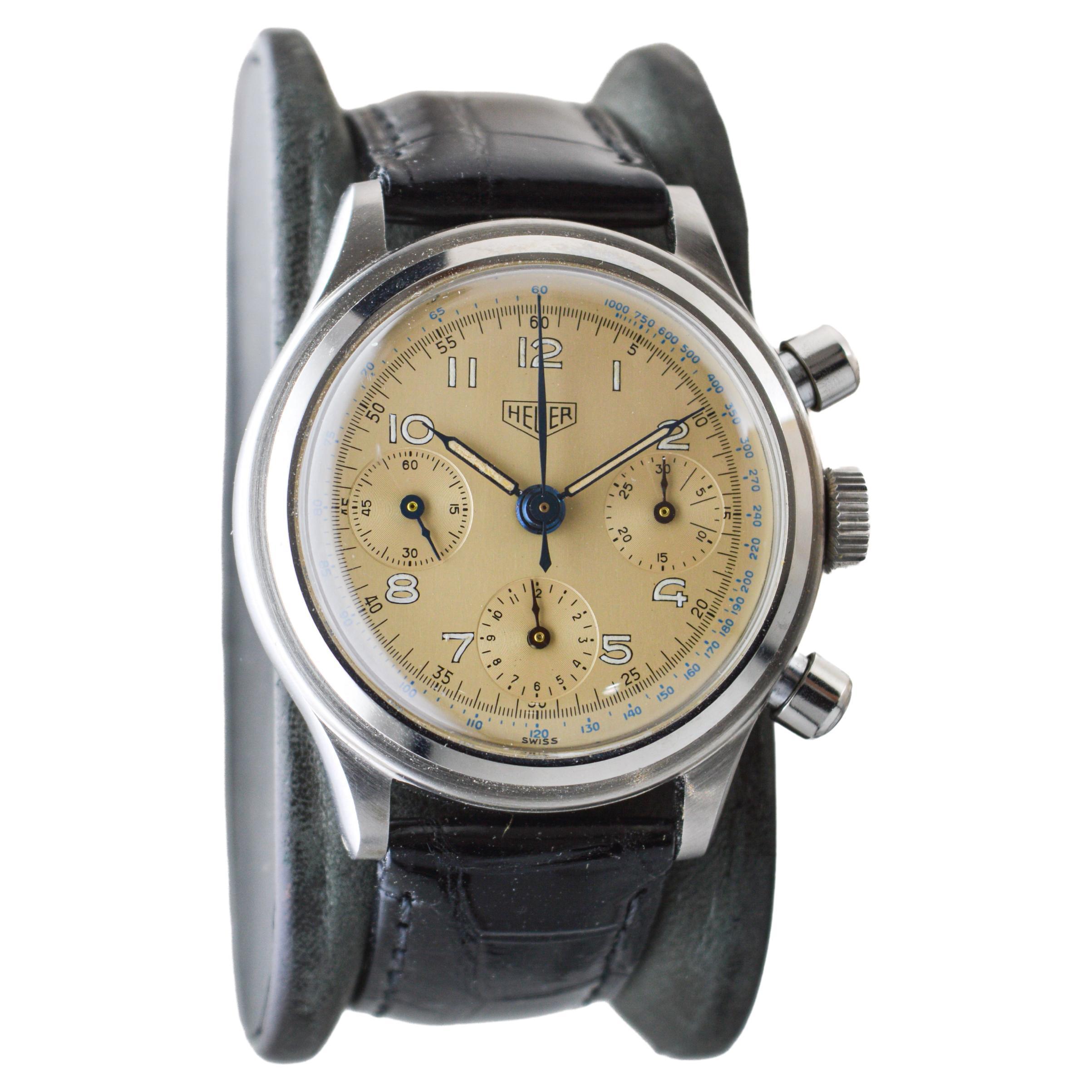 FACTORY / HOUSE: Heuer Watch Company
STYLE / REFERENCE: Three Register Chronograph
METAL / MATERIAL: Stainless Steel 
DIMENSIONS: Length 43mm X Diameter 37mm
CIRCA: 1950's
MOVEMENT / CALIBER: Manual Winding / 17 Jewels / Caliber Valjoux 726 
DIAL /