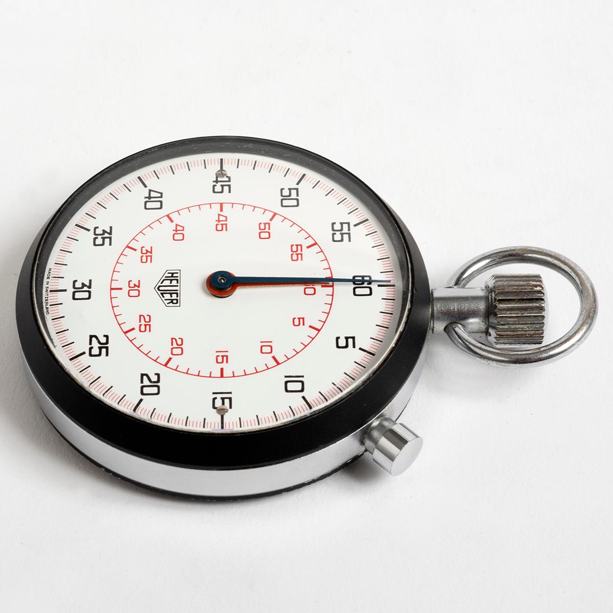 Our manually wound Heuer stopwatch features a 58mm case with 1/10 seconds, 60 minute counters in red and black, engraved P16 to the base. The archetypal motorsports and sports timer of the 1970s, from when we date this example. The overall condition
