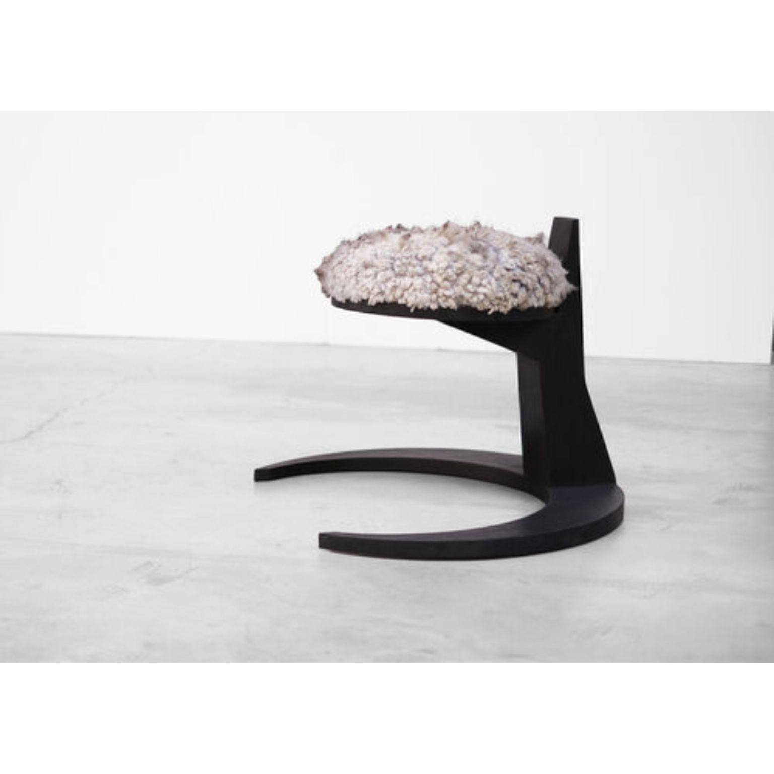 Hevioso stool - Arno Declercq
Burned and waxed Iroko wood finished with a sheep wool fixed seat. 
Other finishes and colors possible. 
Measures: 80 cm wide x 71 cm long x 60 cm high

Arno Declercq
Belgian designer and art dealer who makes bespoke