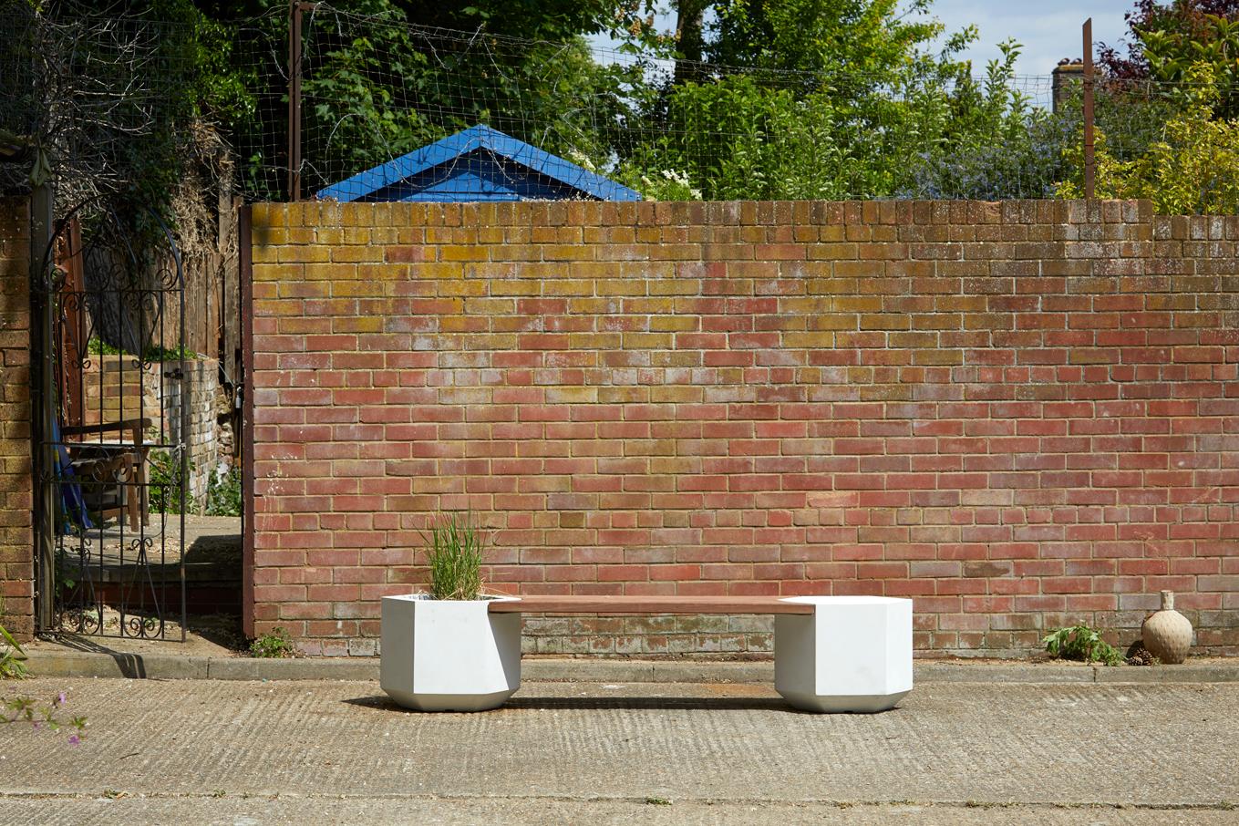 The hex-bench available in two widths 150cm or 180cm. This striking bench has a planter at 1 or both ends, it is handcrafted for the outdoors is made out of glass-reinforced concrete and reclaimed Ekki.

Glass-reinforced concrete considerably