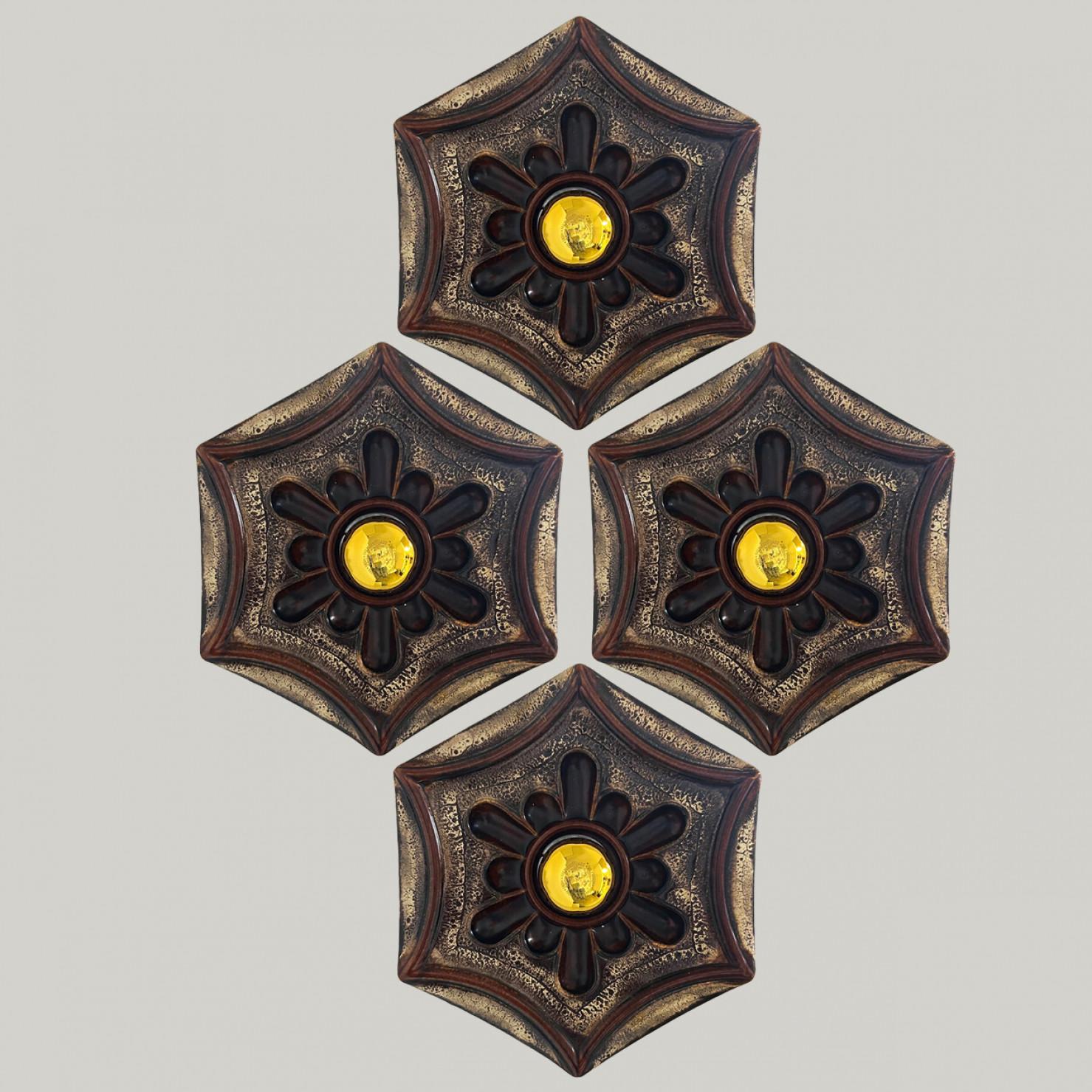 Brown hex- and star-shaped ceramic wall lights in Fat Lava style. Manufactured in Germany in the 1970s. The base of the light is hexagonal and there is a beautiful ceramic flower on top of that.

The style of the glaze is called 'Fat Lava'. Which