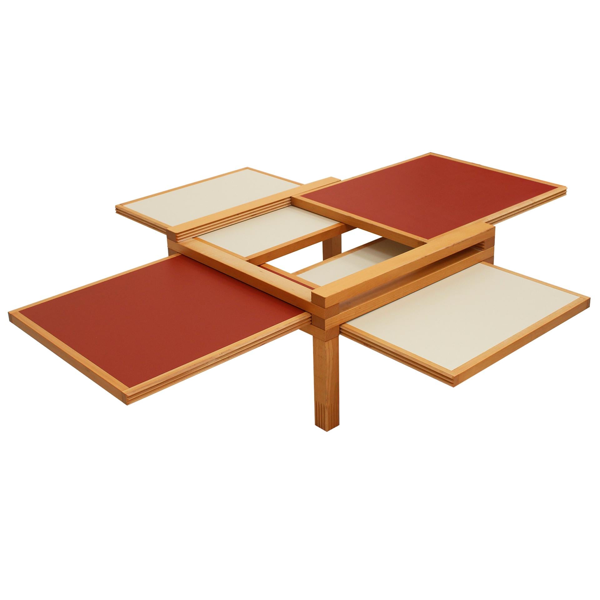 The Hexa model table, designed by Bernard Vuarnesson and edited by Bellato, is a functional and original piece crafted in wood. This table stands out for its four reversible sliding tops in orange and cream, allowing the surface to expand in all