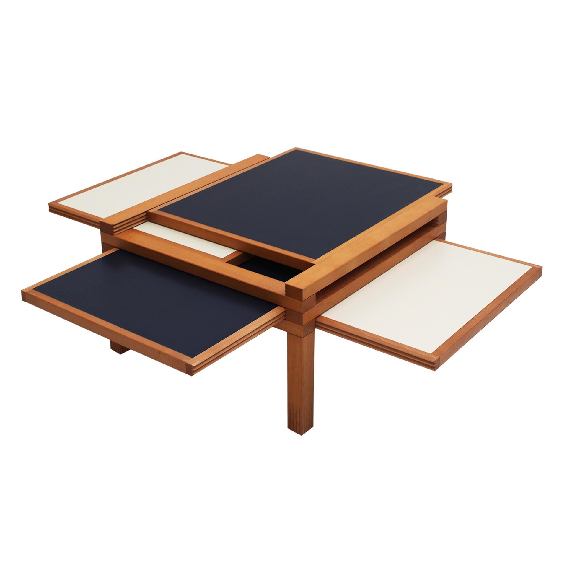 The Hexa model table, designed by Bernard Vuarnesson and edited by Bellato, is a functional and original piece crafted in wood. This table stands out for its four reversible sliding tops in blue and cream, allowing the surface to expand in all