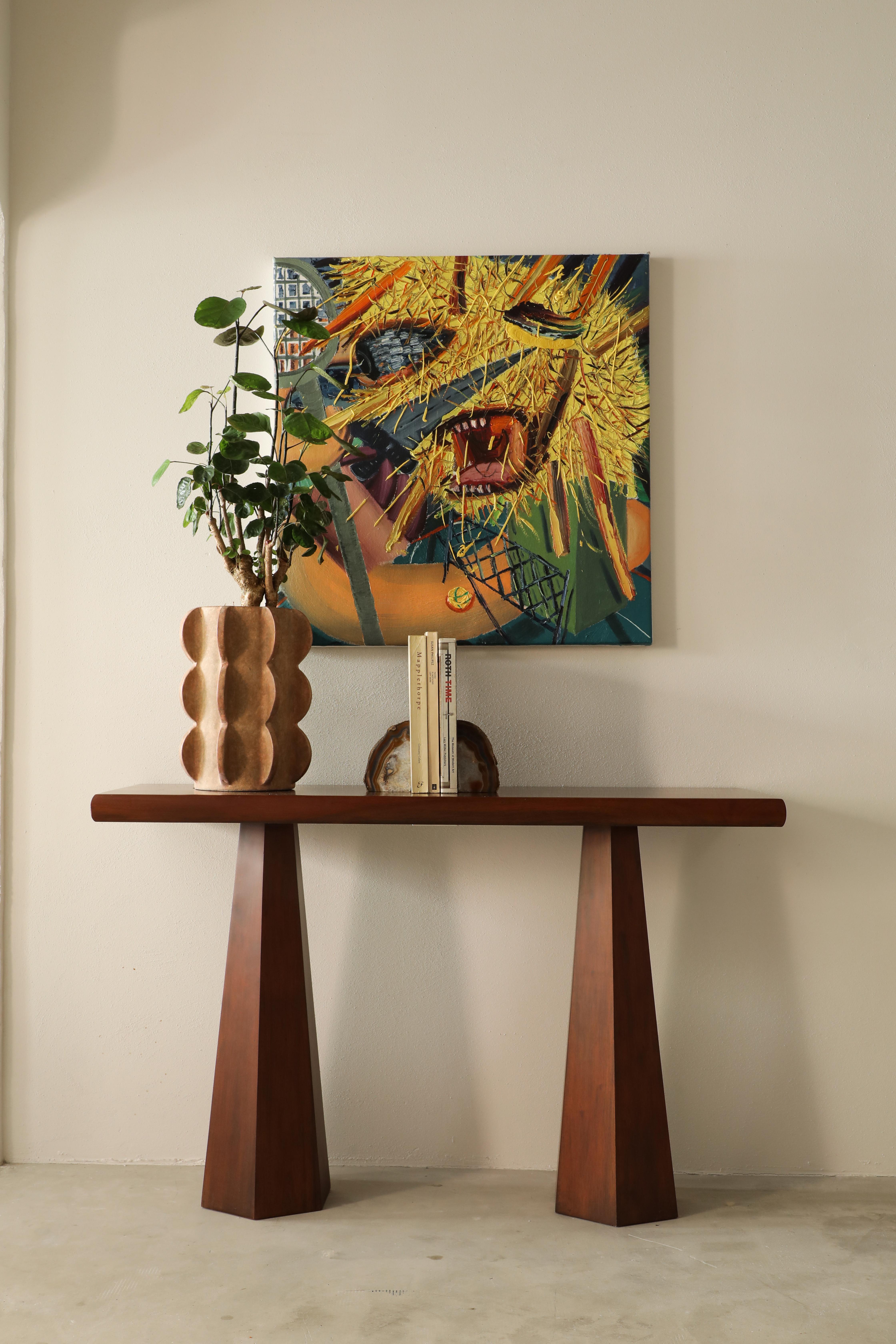 Hexagon Console Table Stained Ash is a modern console table made of solid stained ash. A rectangular tabletop sits on the two bases with a hexagonal shape.

Thanks to the fact that Hexagon Console Table is slightly smaller in size, it is easy to