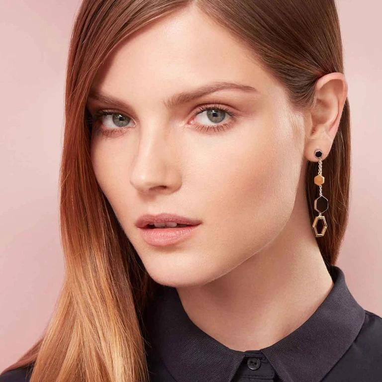 Delicate and dangling. Three different sized hexagons hang from a fine chain, making this pair of statement earrings both feminine and edgy. 


