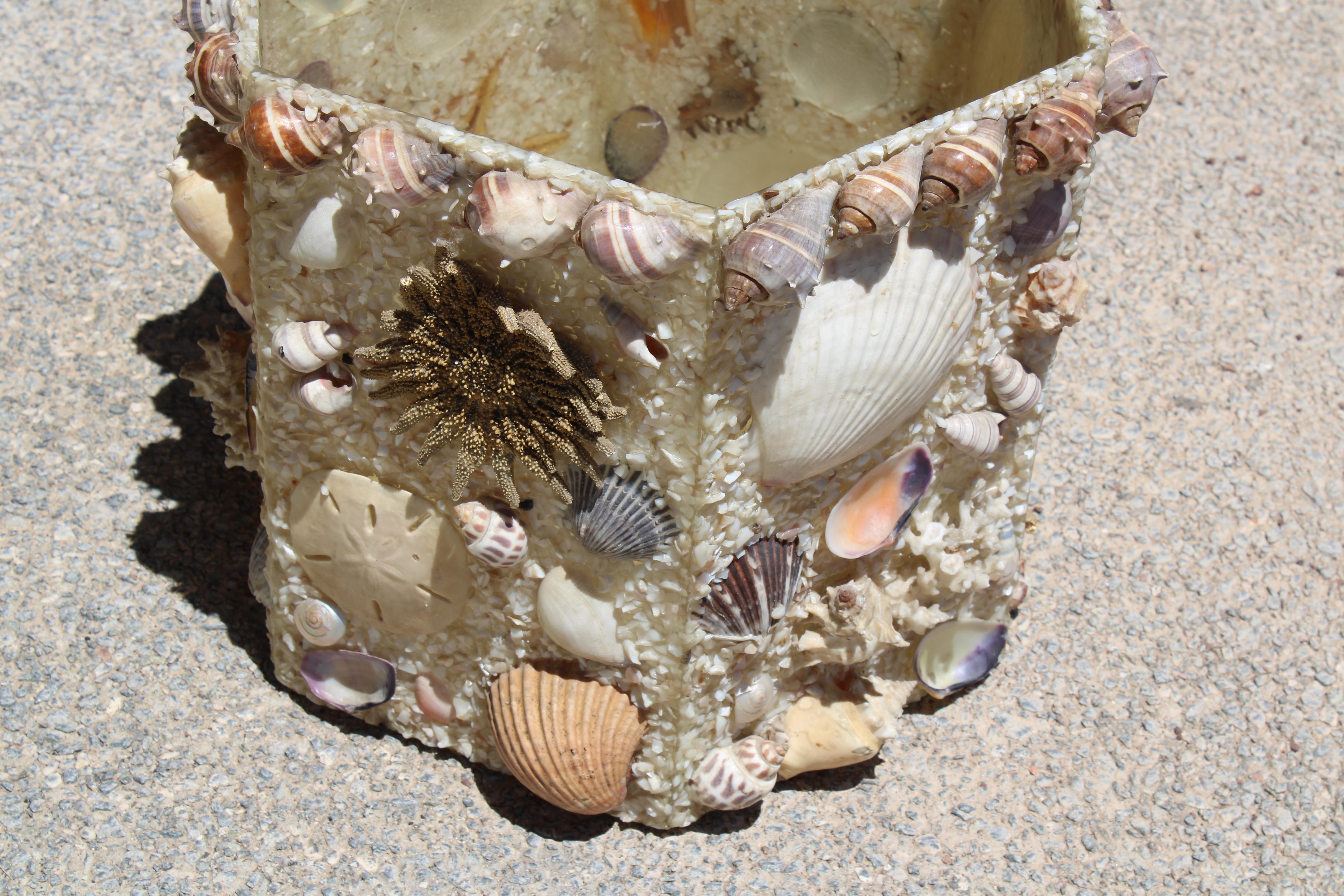 Six sided resin waste basket or planter embellished with nautical seashells. Waste Basket measures 13.5