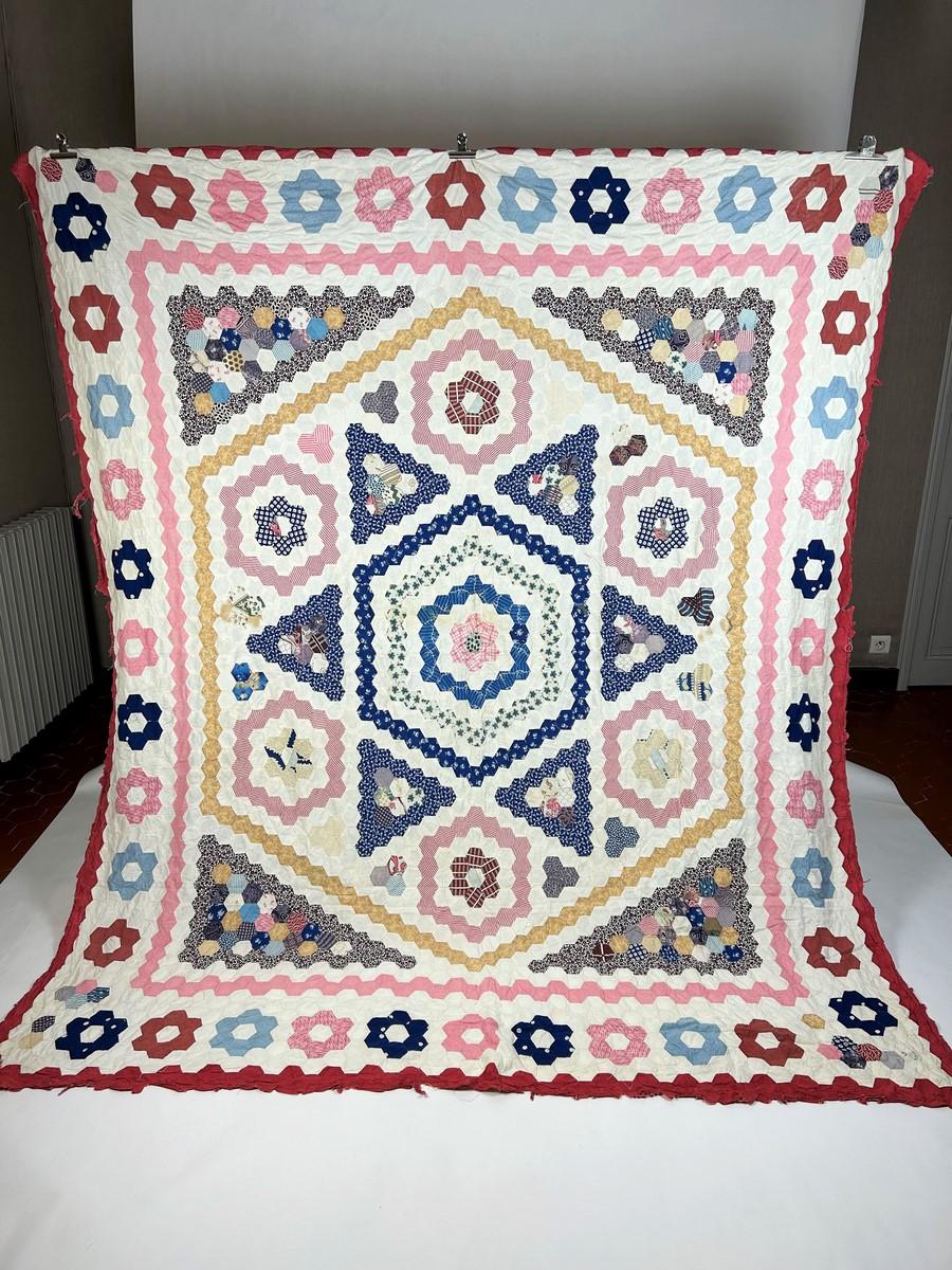 Circa 1860
United States

Spectacular American hexagon patchwork circa 1860. Entirely hand-sewn from printed cotton and Indian hexagons, all dated between 1810 and 1850. Design with large central star playing on the polychromy and geometry of