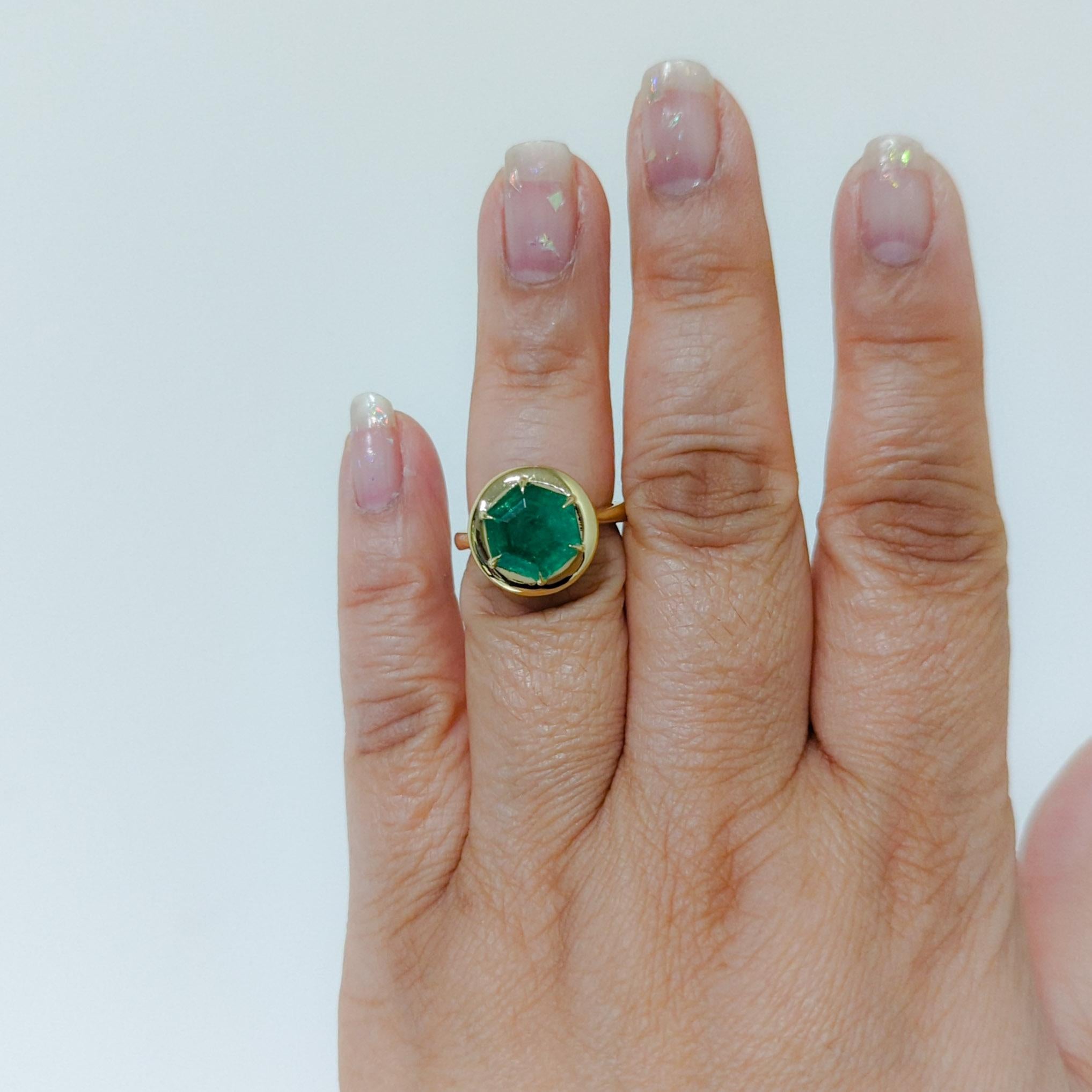 Beautiful 3.94 ct. emerald hexagon in a handmade 18k yellow gold mounting.  Ring size 6.25.