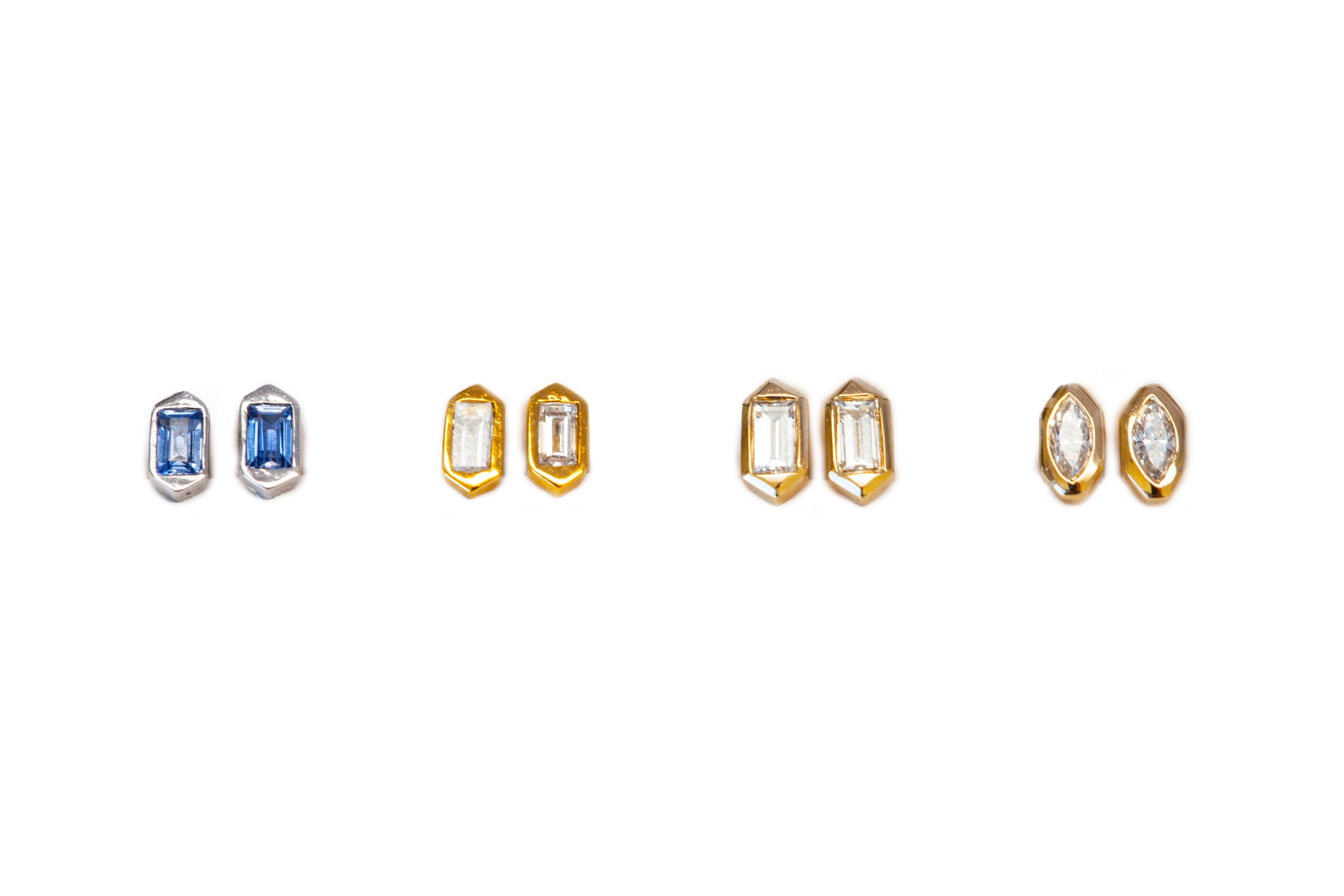 Hexagon shaped stud earrings with baguette diamonds in 18k yellow gold.
