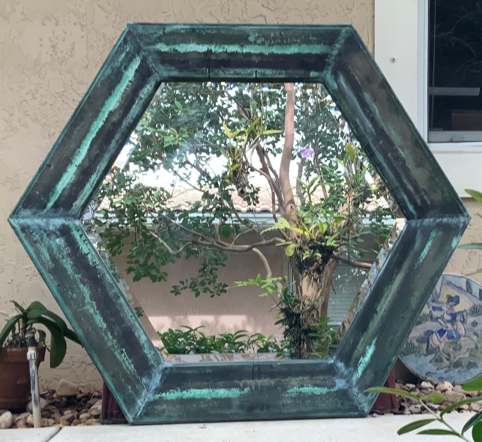 One of a kind mirror made of wood frame covered artistically with Antique copper layer. Beveled 1.5 inch 
Mirror glass with a great oxidized greenish patina.
The copper layer in the mirror has its story on the back of the mirror to read, it look