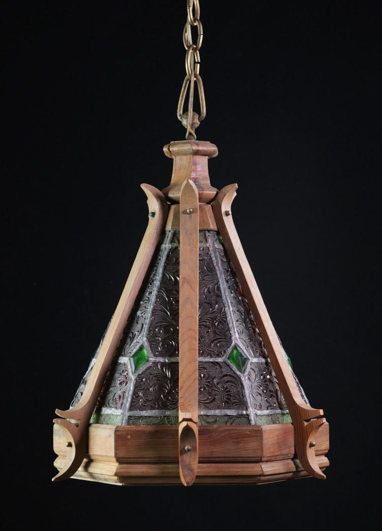 20th Century Gothic and Folk style wood frame hexagon pendant light featuring leaded stained glass done in red and green colors. Minor cracks in the wood. Please see photos. Please specify the overall drop that is needed upon purchasing.