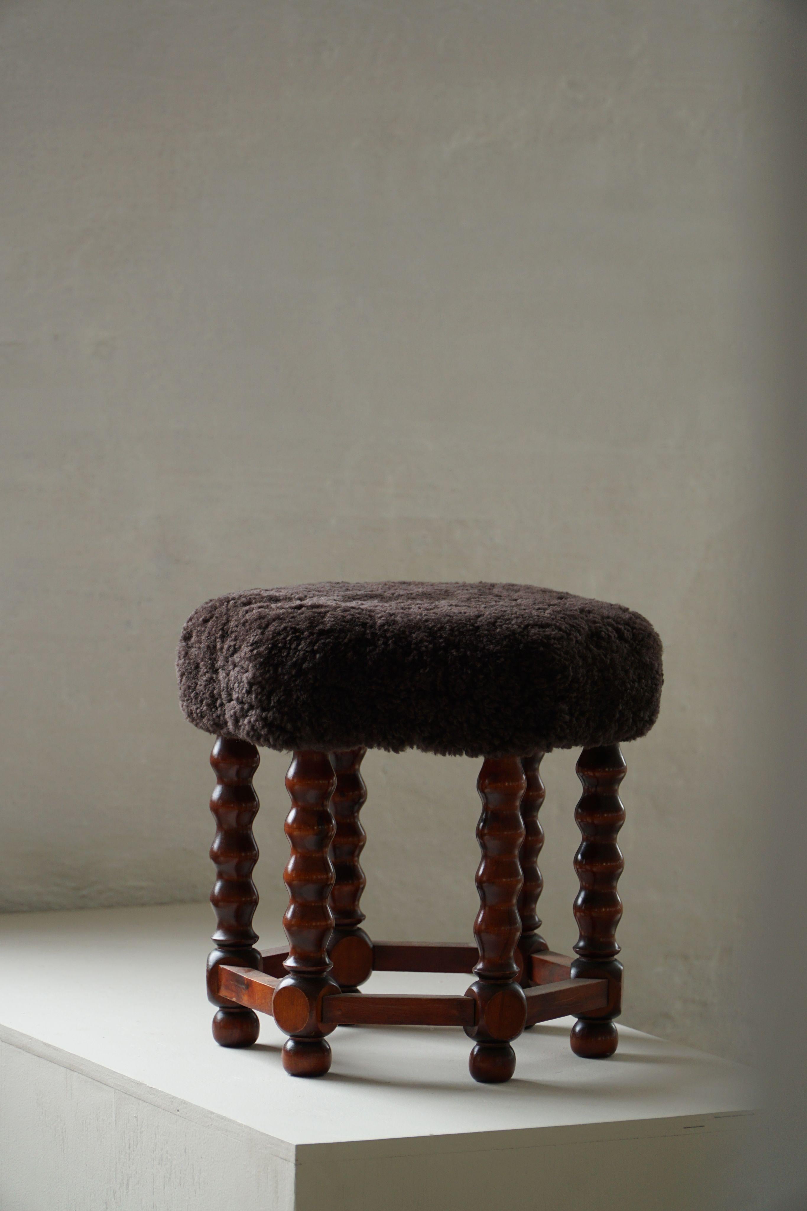 This charming Danish modern stool was crafted in the 1950s by a skilled cabinetmaker, exemplifying the quiet elegance and tactile richness of mid-century Scandinavian design. The hexagonal seat has been thoughtfully reupholstered in dark brown