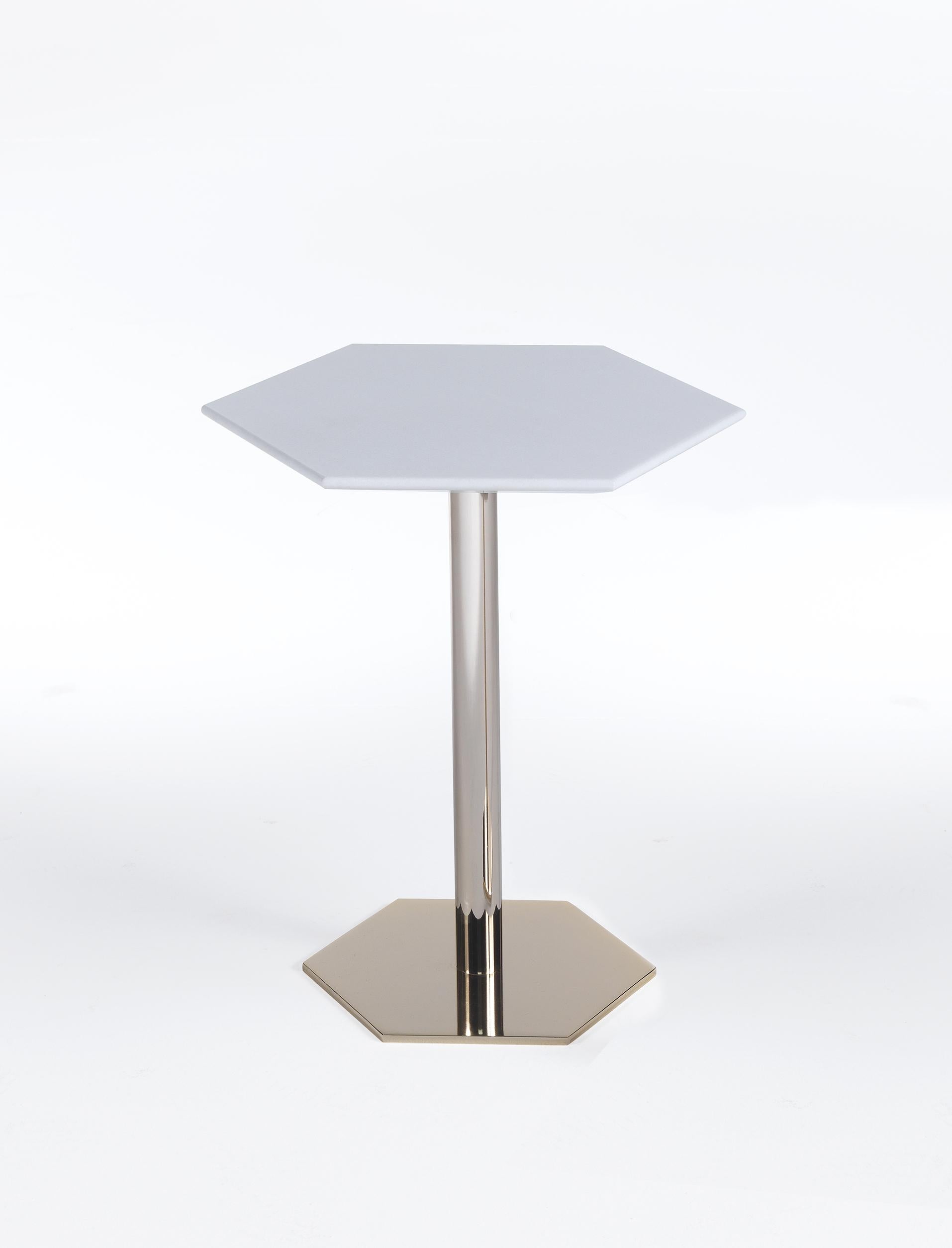 The eye-catching tall side table is perfect to enhance a modern interior or to add a fresh, contemporary look to a traditional one. The side table is composed of a one-legged polished brass base, that stems from an hexagonal foundation. The