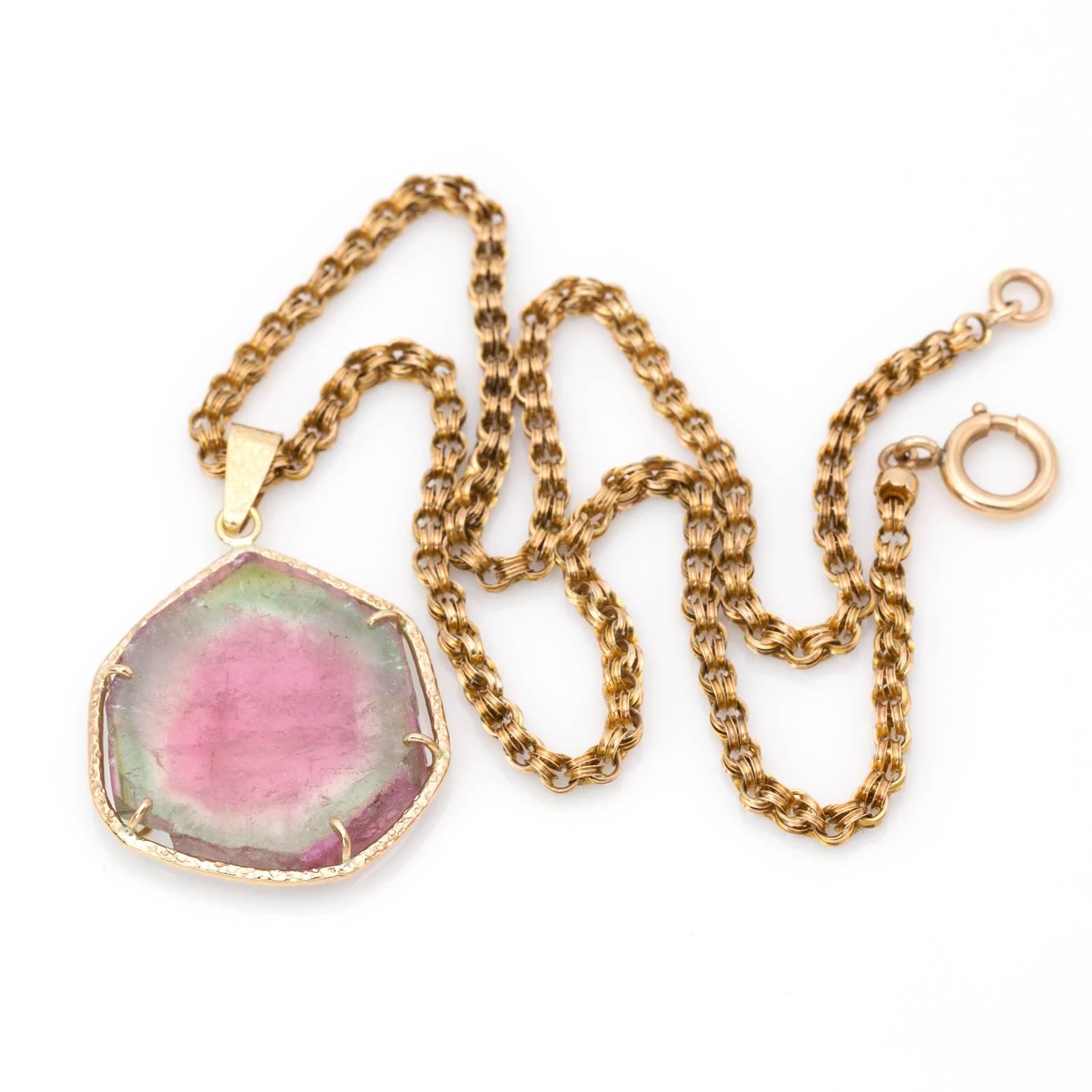 Pink and green watermelon tourmaline set in 14K yellow gold and embellished with hammered detail. This pendant speaks for itself in intricacy, detail and the natural beauty of nature to create such a magnificent piece. Handmade in the San Francisco