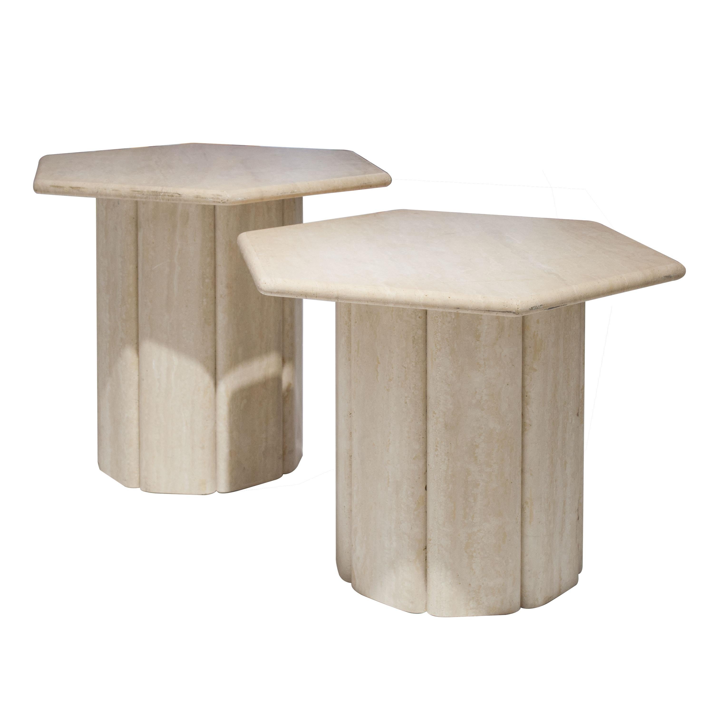 Set of two side tables made of travertine marble. Faceted cylinder base with hexagon shaped top. Two different heights (47/42 cm; 18,5/16,5 inches).