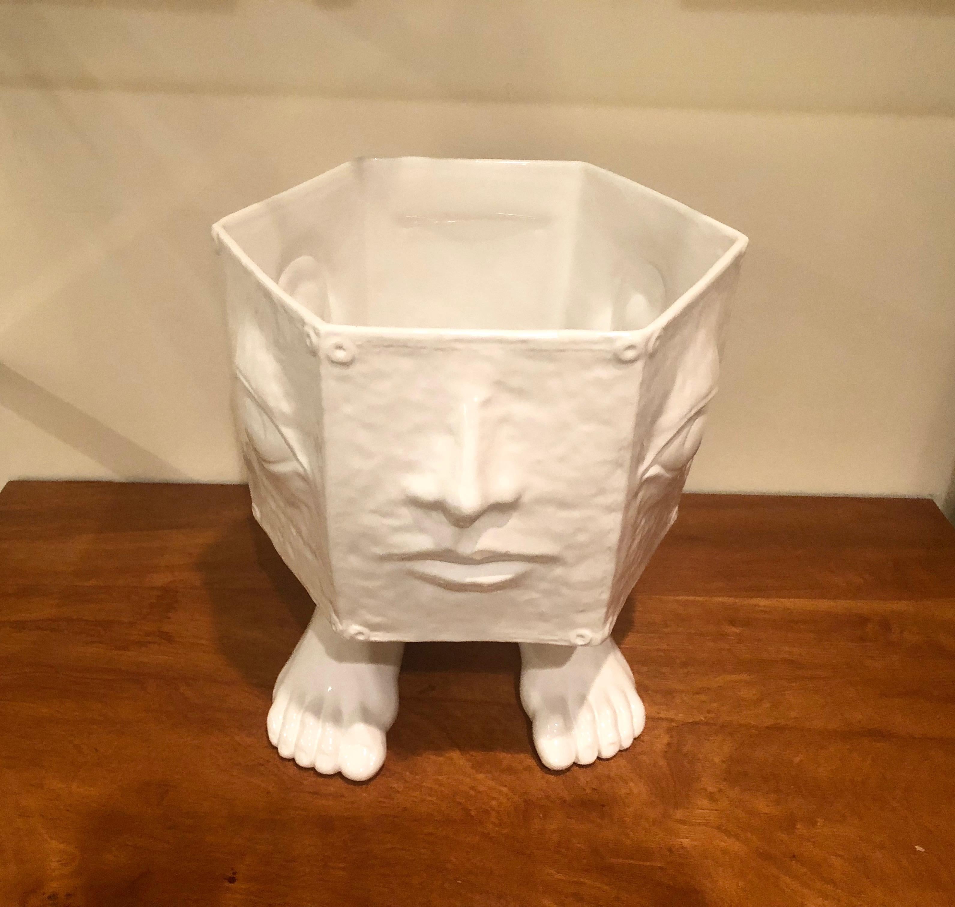 Italian hexagonal shaped planter by 'Taste Setter by Sigma' in white textured glaze ceramic that has a body feature on each side (a nose and mouth on the front, a left eyeball, a left ear, a pentagonal shape on the back side, a right ear, and a