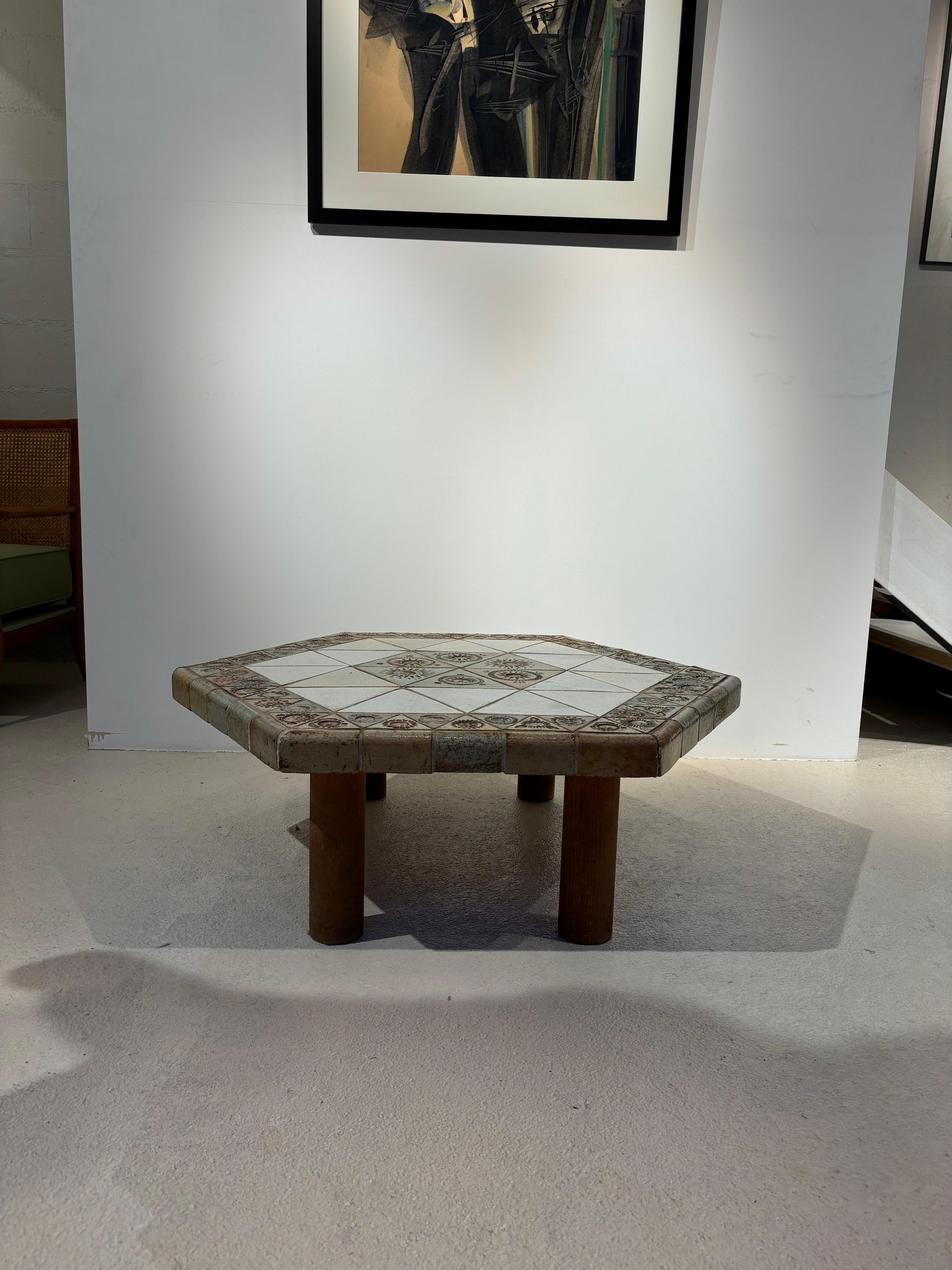 Jolie table hexagonale par Roger Capron à décor figuratif, de soleil. 