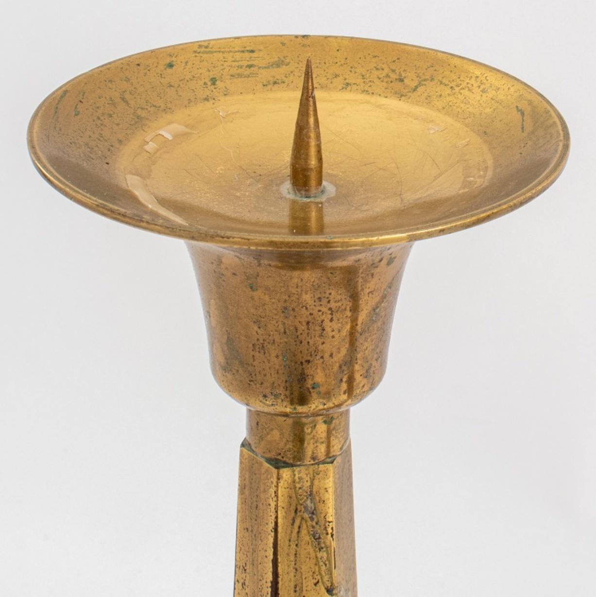 Pair of hexagonal columnar brass pricket sticks on circular bases, each with round drip pans above shaped hexagonal uprights. 

Dimensions: 16