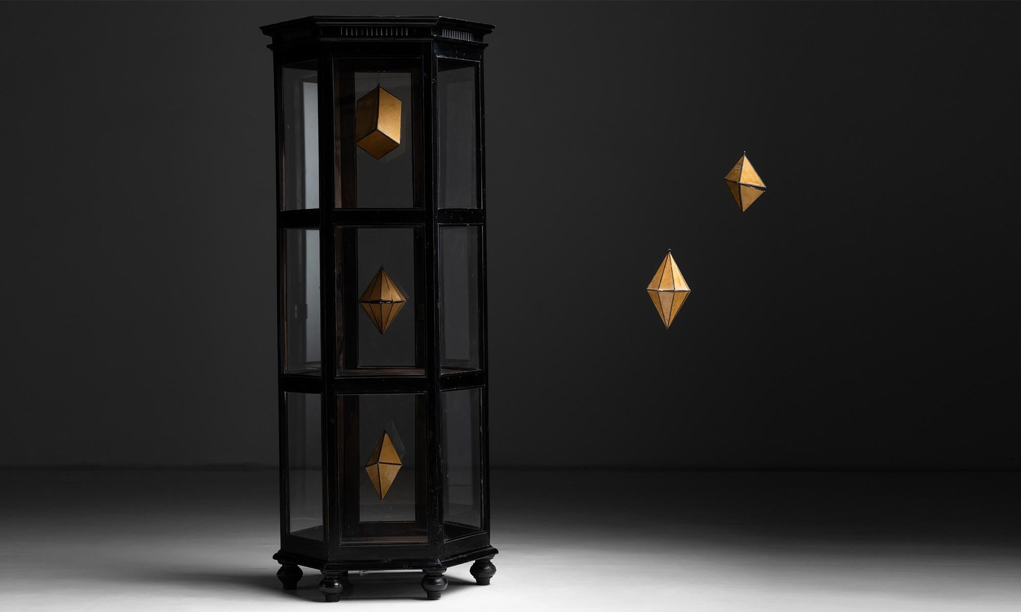 Hexagonal Display Cabinet, England, circa 1910

Tiered shelving display case with ebonised wood and key included

Measures 29”w x 24.75”d x 69.25”h.