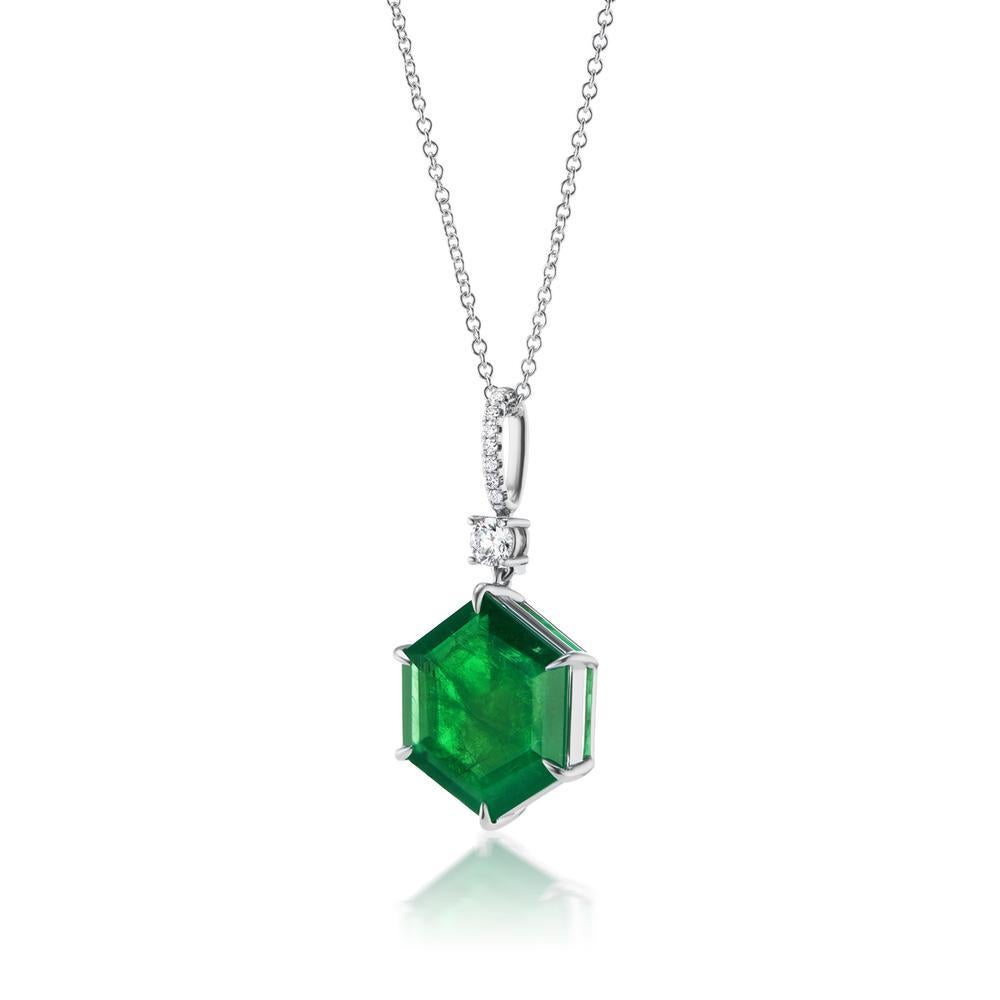 HEXAGONAL
EMERALD AND DIAMOND NECKLACE
This 18k white gold pendant exhibits a sophisticated allure of geometry.
The star of this gorgeous necklace is the hexagonal shaped 13 ct deep
green Emerald
Item: # 04074
Metal: 18k White Gold
Color Weight: